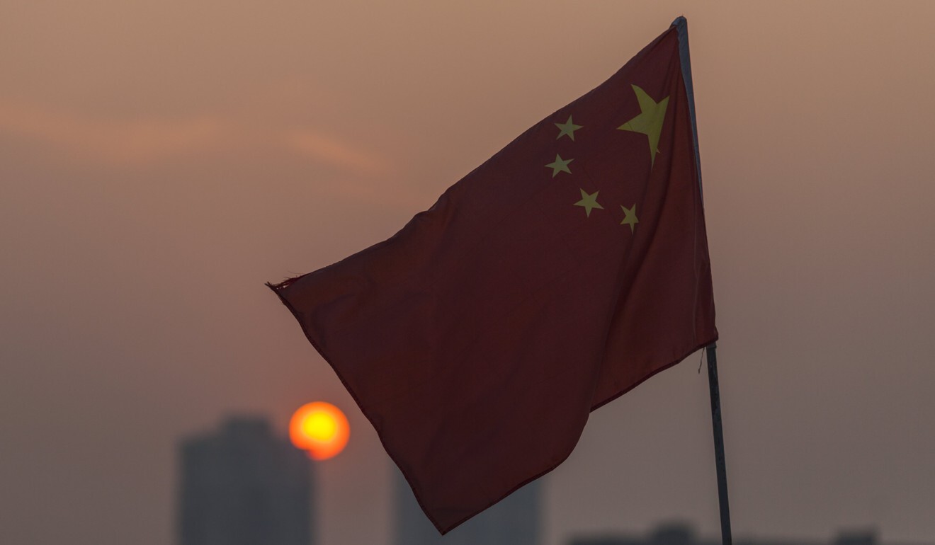 A Chinese flag hangs on a boat as the sun sets over Guangzhou city. Vietnam has the largest fishing fleet operating in the South China Sea – 129,519 vessels vs 92,312 for China, according to figures in 2012. Photo: EPA-EFE