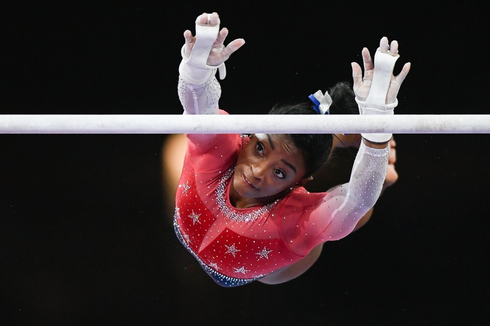 Simone Biles competes in the women’s asymmetric bars during the 2019 World Artistic Gymnastics Championships. The American has yet to commit to competing at the Olympics. Photo: DPA