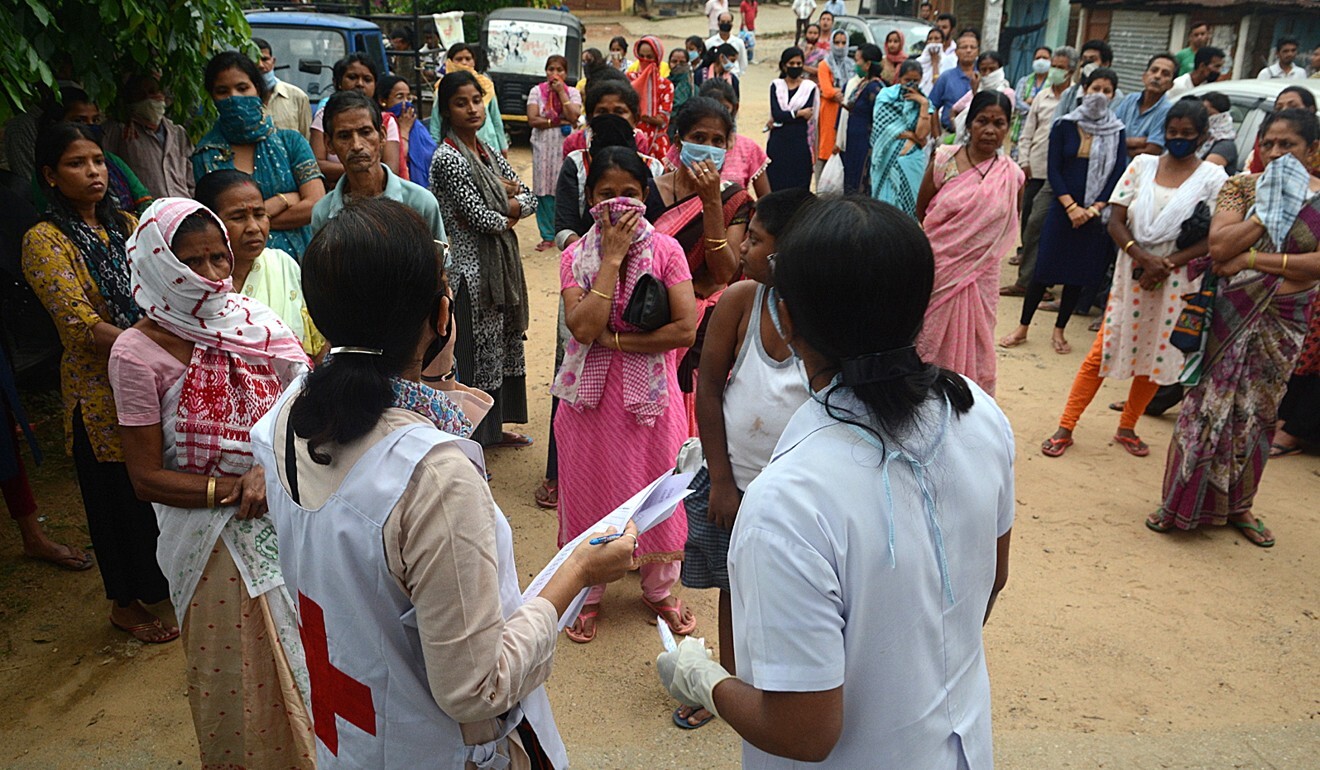 People wait in queue to collect food packets provided by Indian Red Cross Society in Guwahati during a nationwide lockdown. Photo: EPA-EFE
