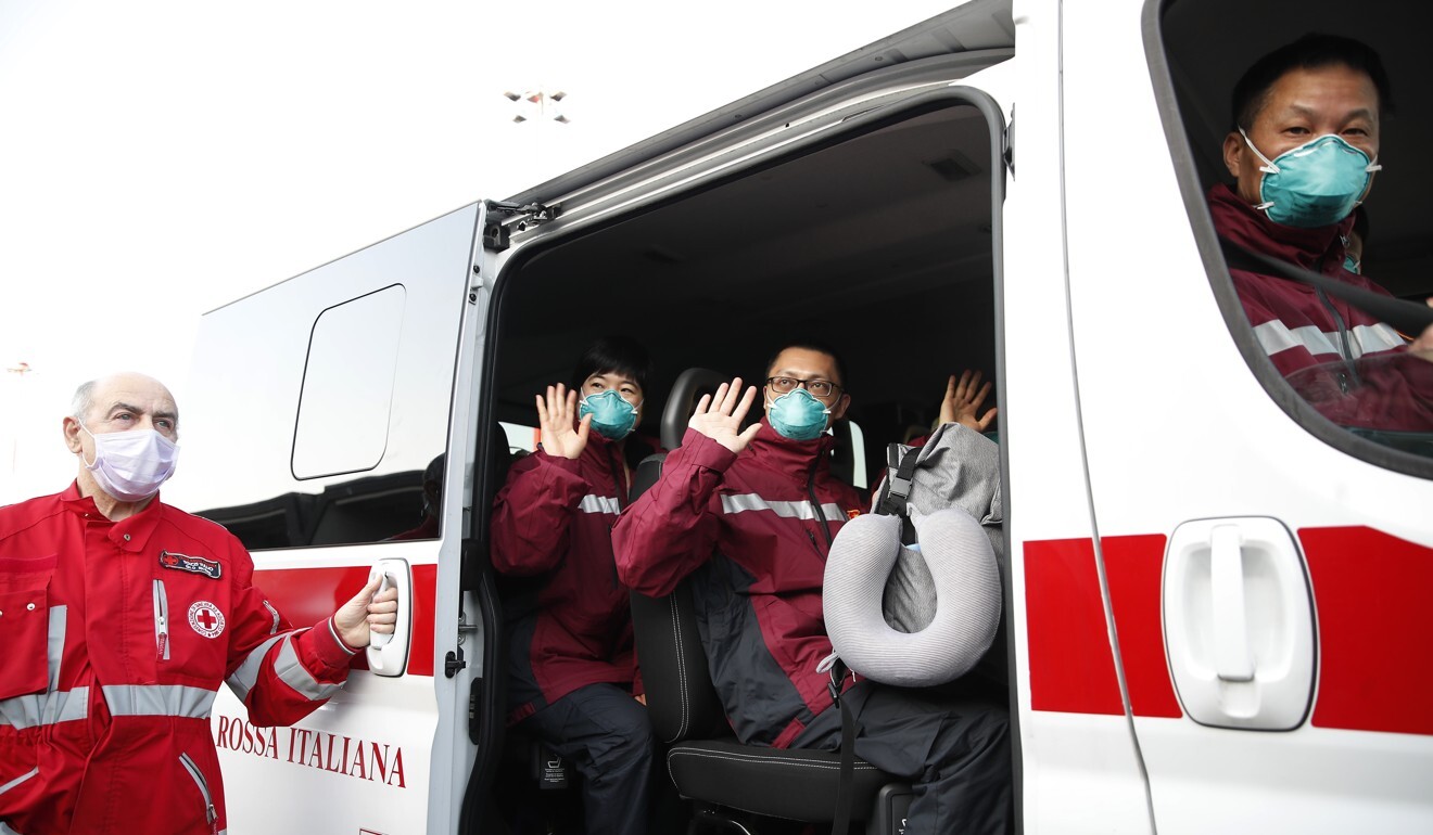 Medics and paramedics from China salute as they board a Red Cross vehicle upon arrival in Milan, Italy, on March 18. Some 37 medical staff were sent from China along with 18 tonnes of equipment. Photo: AP
