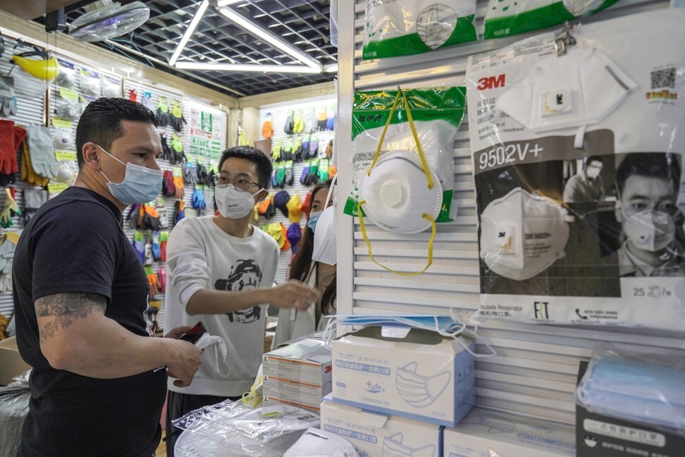A foreign buyer visits a stall selling face masks. Photo: Ren Wei