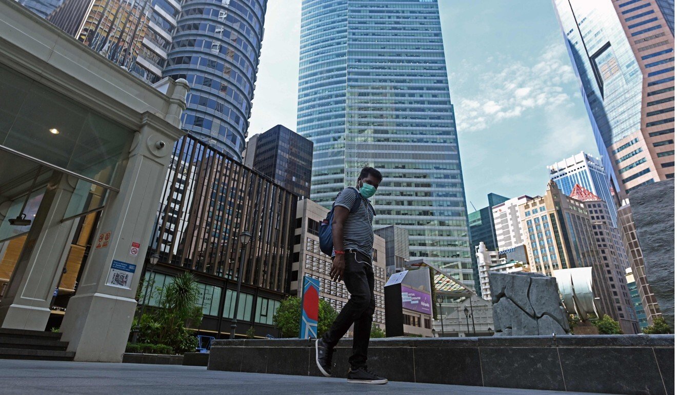 A man wears a face mask while walking in Singapore’s central business district. Photo: AFP