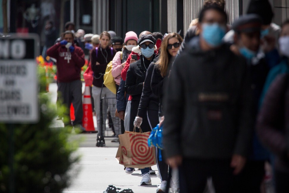 People wearing face masks wait in line to shop at a store in the Brooklyn borough of New York on April 14. Masks and other personal protective gear are in high demand as the world grapples with the coronavirus outbreak. Photo: Xinhua