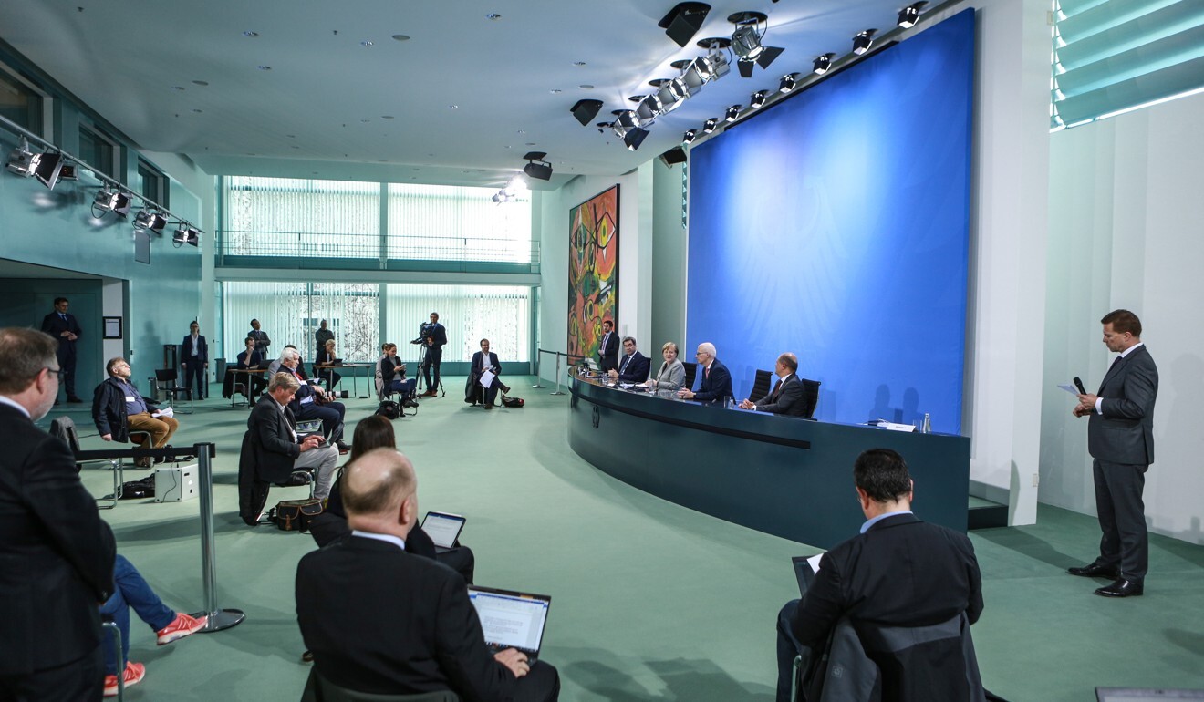 Reporters practice social distancing at the chancellery in Berlin on Wednesday during a government press conference led by German Chancellor Angela Merkel. Photo: EPA-EFE