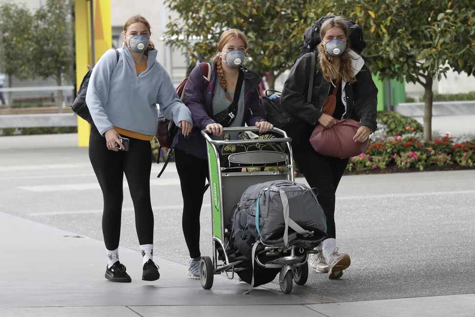 Foreign tourists arrive outside the Christchurch Airport terminal as they prepare to check in for a charter flight back to Germany on April 6. Photo: AP