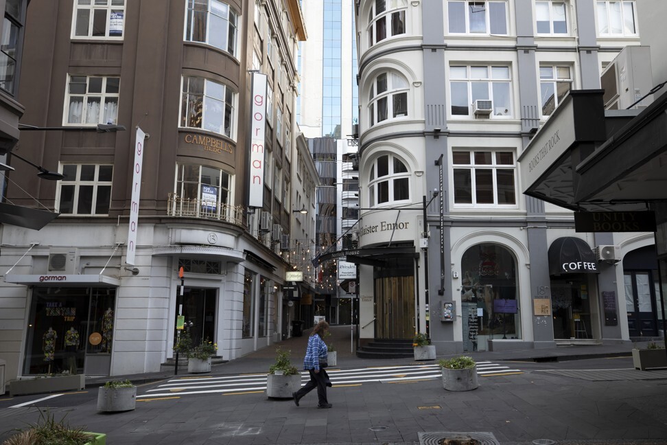 A pedestrian walks along an empty street during a lockdown in Auckland. Photo: Bloomberg