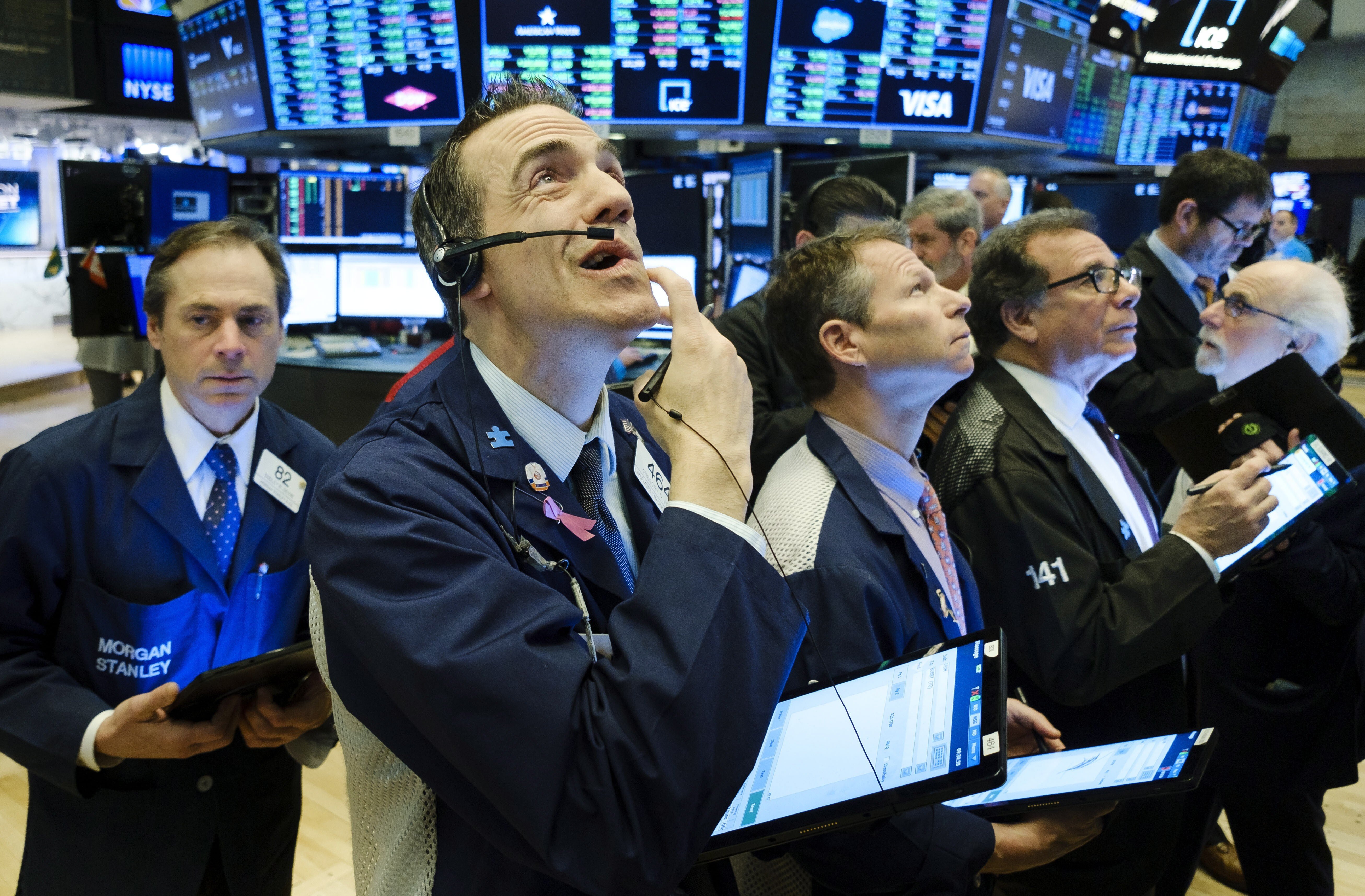 Traders work on the floor of the New York Stock Exchange on March 4. US and global equities are currently down by less than 20 per cent from their all-time highs. Photo: EPA-EFE