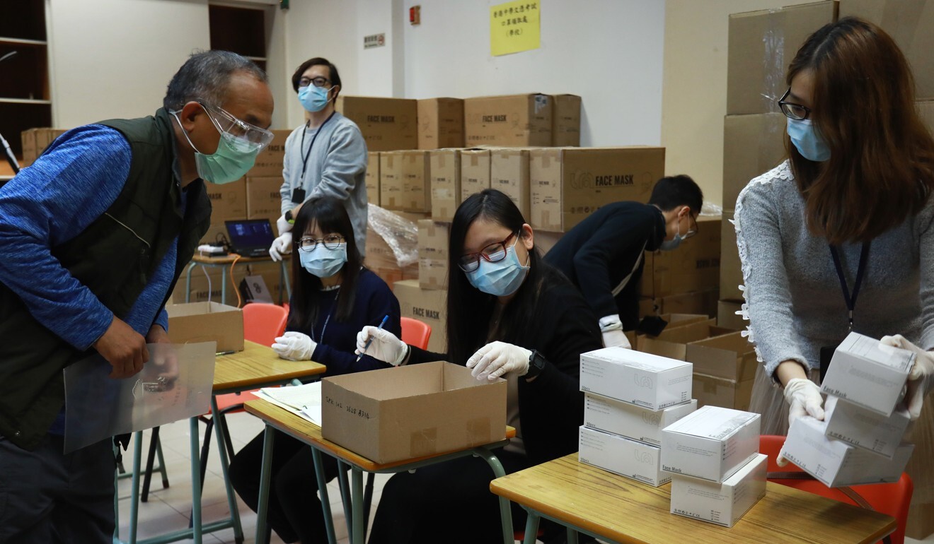 A school representative collects a box of protective face masks for DSE candidates at the Hong Kong Examinations and Assessment Authority office in San Po Kong. Photo: May Tse