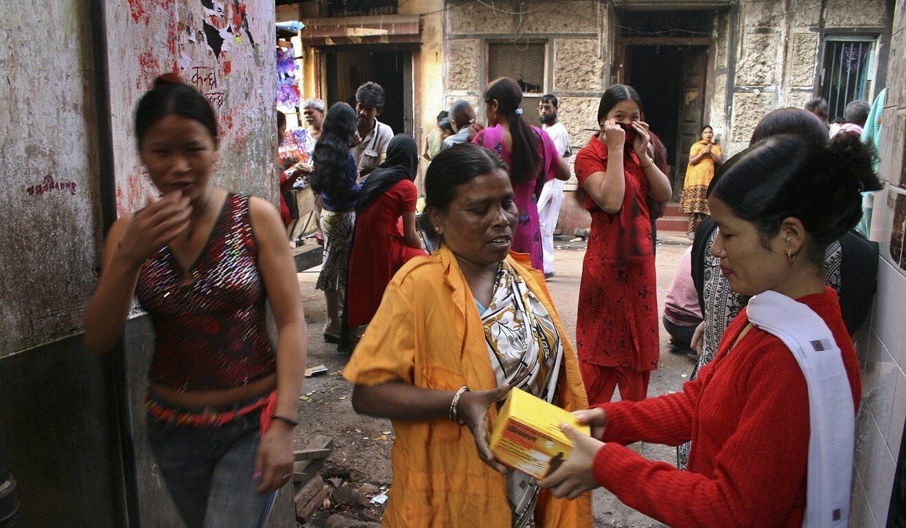 A volunteer distributes condoms to sex workers in Sonagachi, the biggest red-light district in the eastern Indian city of Kolkata. Photo: Reuters