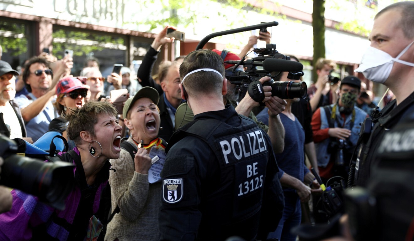 People shout at police at a protest in Berlin against the lockdown. Photo: Reuters