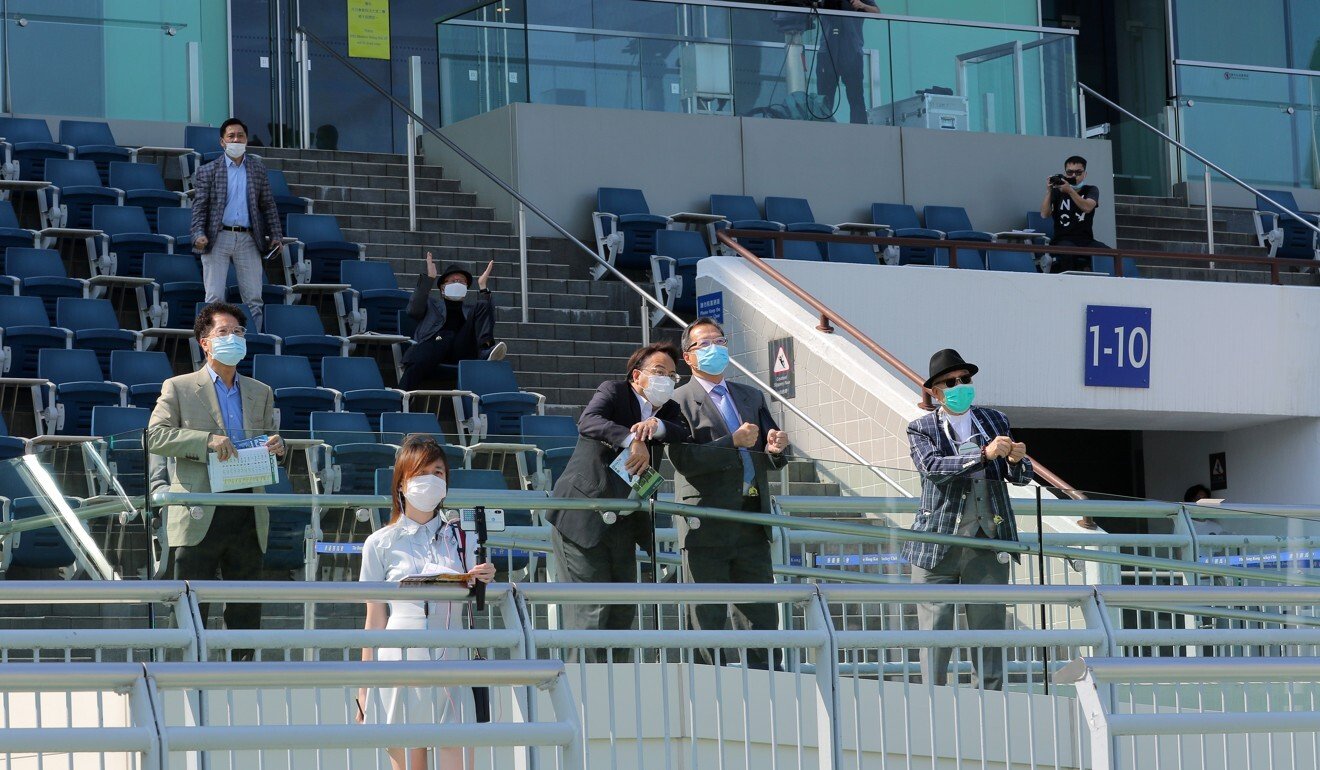 Owners at Sha Tin watch their horse race.