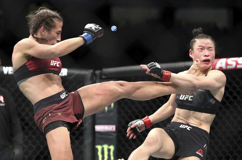 Former champion Joanna Jedrzejczyk lands a kick on Zhang Weili. Photo: AP
