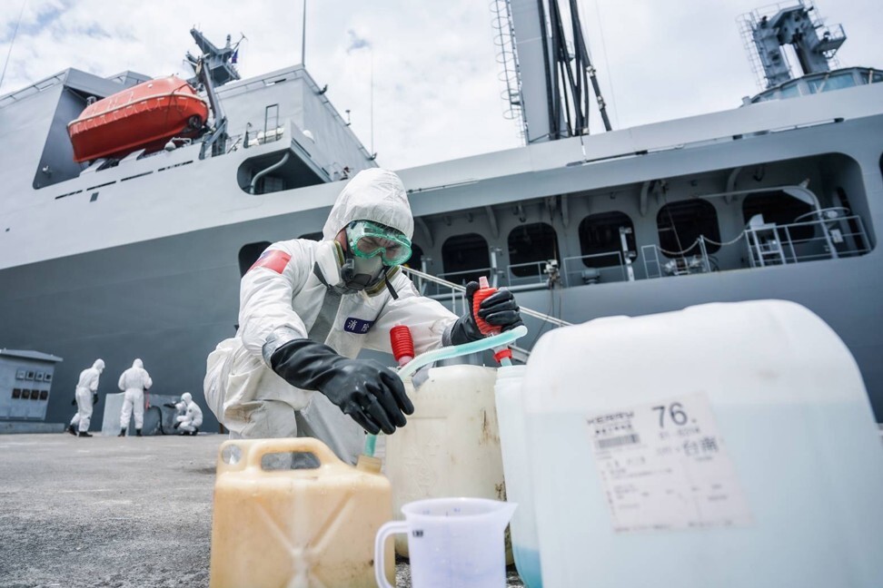 Soldiers from Taiwan’s military disinfect the Panshih supply ship at Zuoying Naval Base after navy personnel tested positive for coronavirus. Photo: Handout