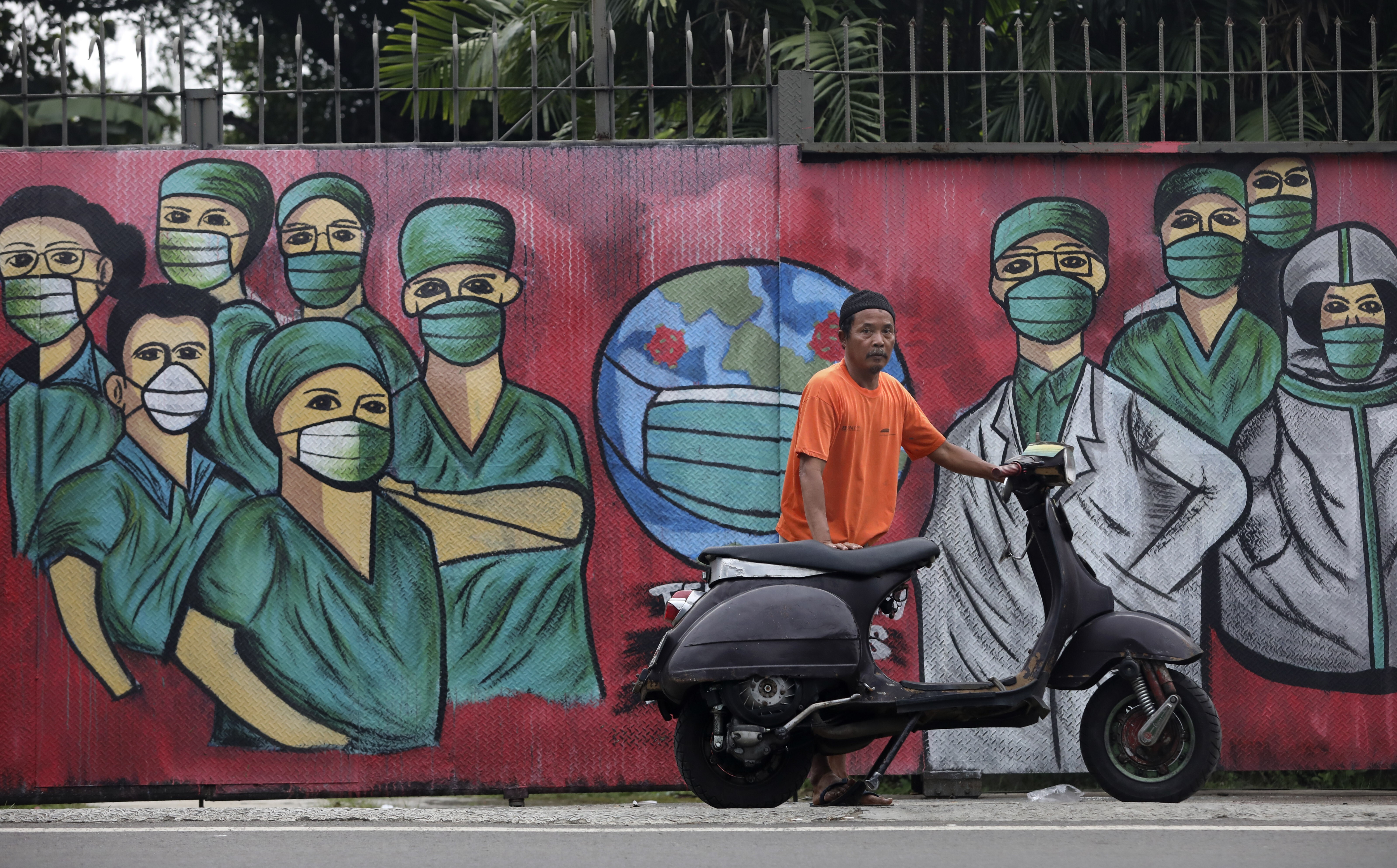 A coronavirus mural in Depok, on the outskirts of Jakarta, Indonesia. Photo: AP