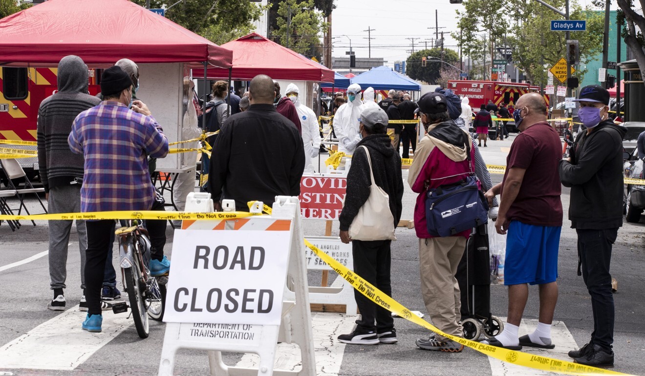 Homeless people wait in line at a Covid-19 pop-up test site in Los Angeles on Monday. Photo: EPA-EFE