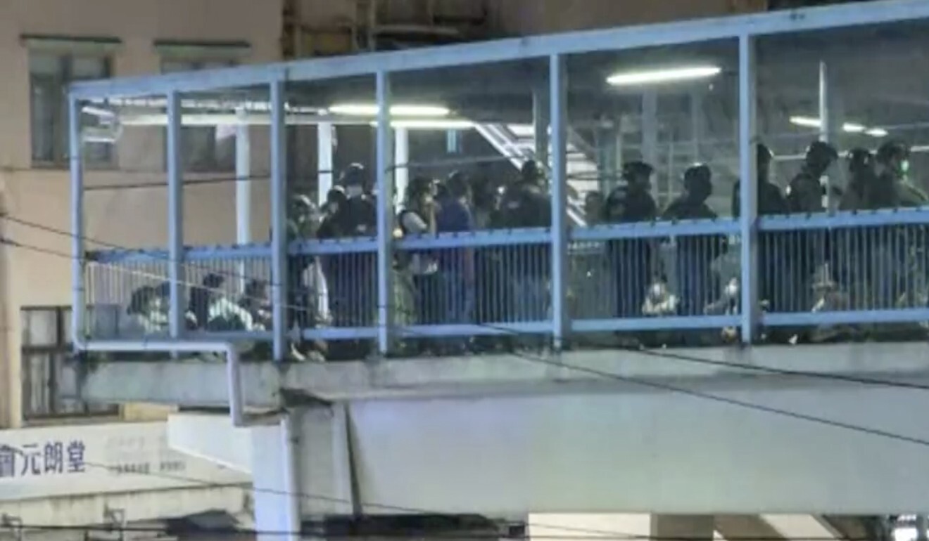 A small crowd gathered on a footbridge in Yuen Long but police moved in quickly. Photo: Now TV