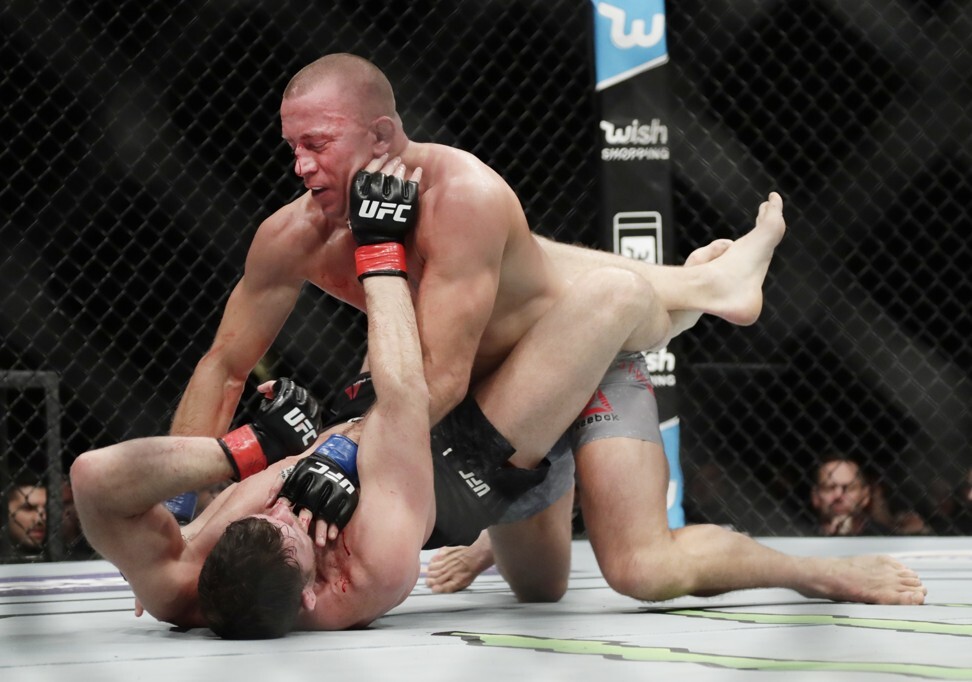 Georges St-Pierre controls Michael Bisping from the top. Photo: AP