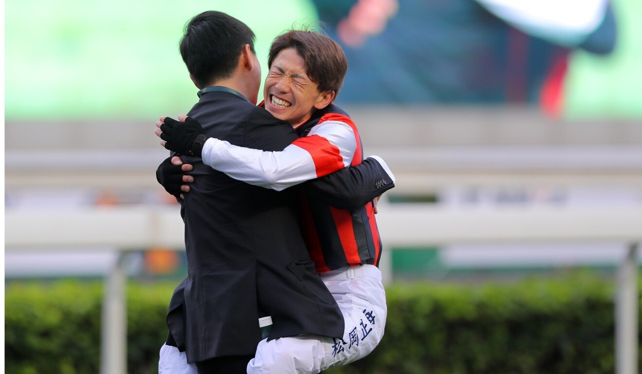 Masami Matsuoka hugs Win Bright’s trainer Yoshihiro Hatakeyama after winning the QE II Cup.