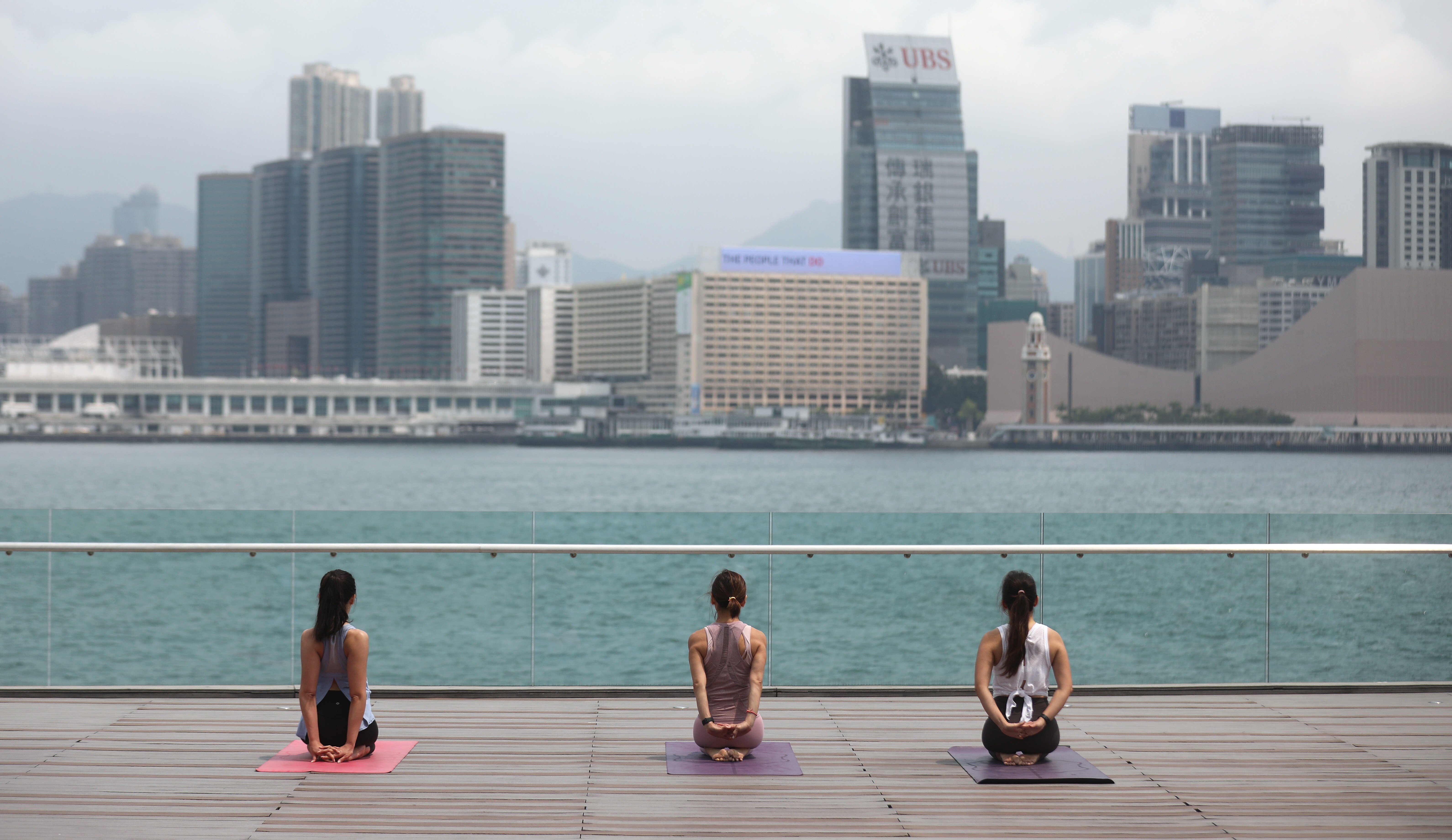 Women practise yoga at Tamar Park in Central on April 21. As the number of new Covid-19 cases in the city drops, Hongkongers are venturing out more. Photo: Winson Wong