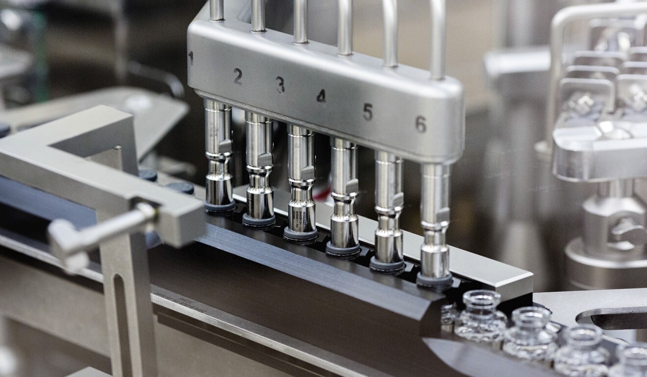 Rubber stoppers are placed onto filled vials of remdesivir at a Gilead manufacturing site in the US in March. Photo”: Gilead Sciences via AP