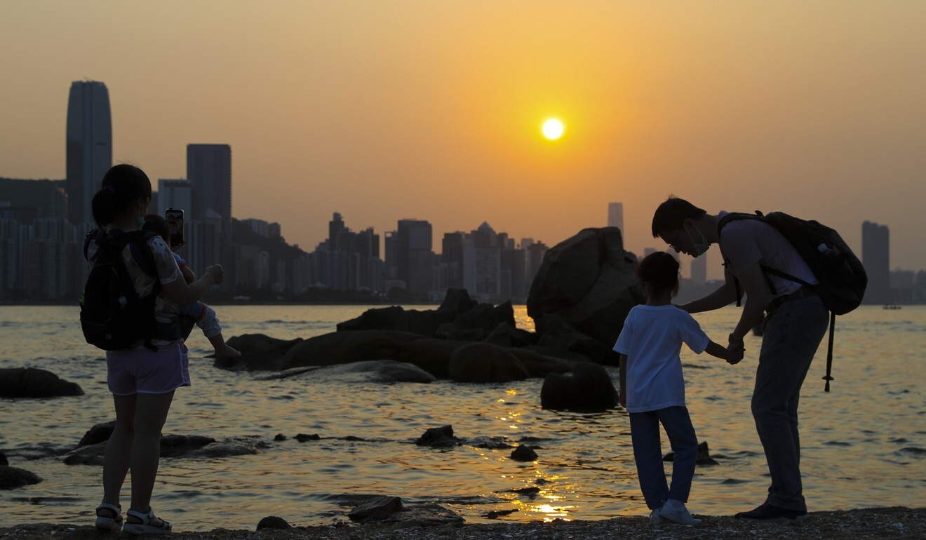 People enjoy the sunset at Lei Yuen Mun on April 19. Many Hongkongers headed out to beaches over the Easter weekend after weeks of being cooped up at home, alarming health care experts. Photo: Edmond So