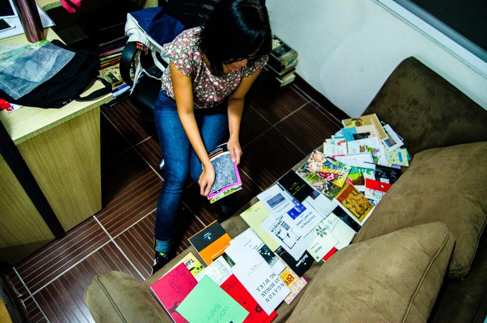 Conchitina Cruz, one of the founders of Better Living Through Xeroxography (BLTX), reviews publications. Photo: Maro Enriquez