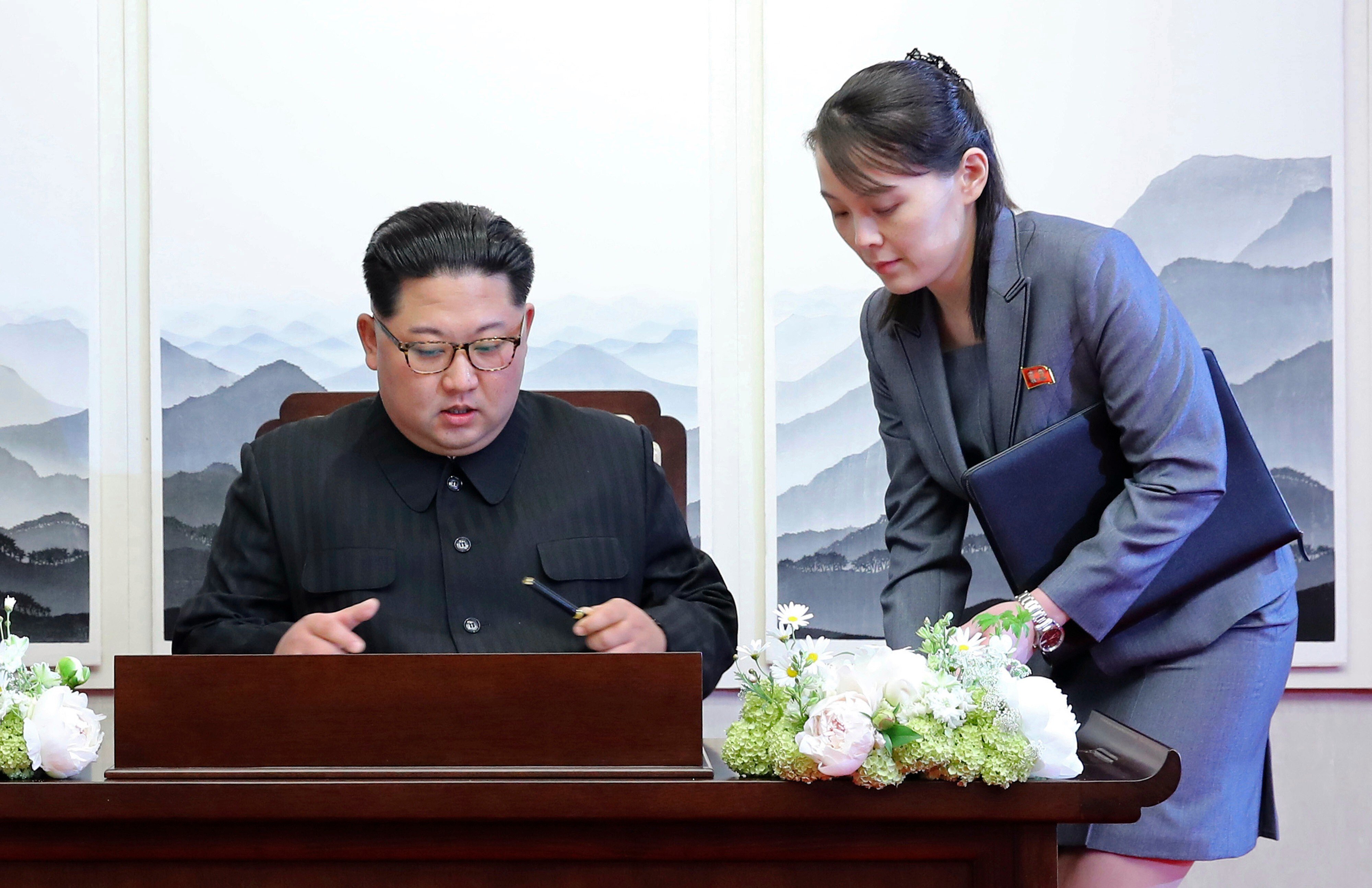 North Korean leader Kim Jong-un signs a guestbook next to his sister Kim Yo-jong inside the Peace House at the demilitarised zone in April 2018. Photo: Korea Summit Press Pool via AP
