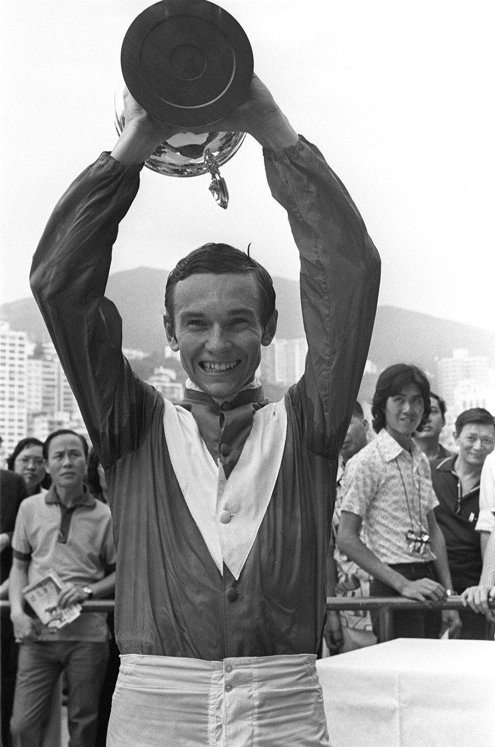 Jockey Gary Moore holds aloft the Champions & Chater Cup after winning aboard Super Win at Happy Valley. Photo: SCMP