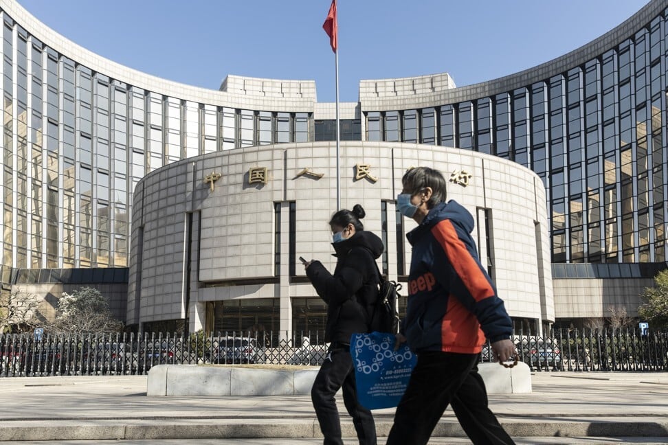 Pedestrians walk past the People's Bank of China headquarters in Beijing on March 17. the central bank’s Digital Currency Research Institute is overseeing development of China’s sovereign digital currency. Photo: Bloomberg