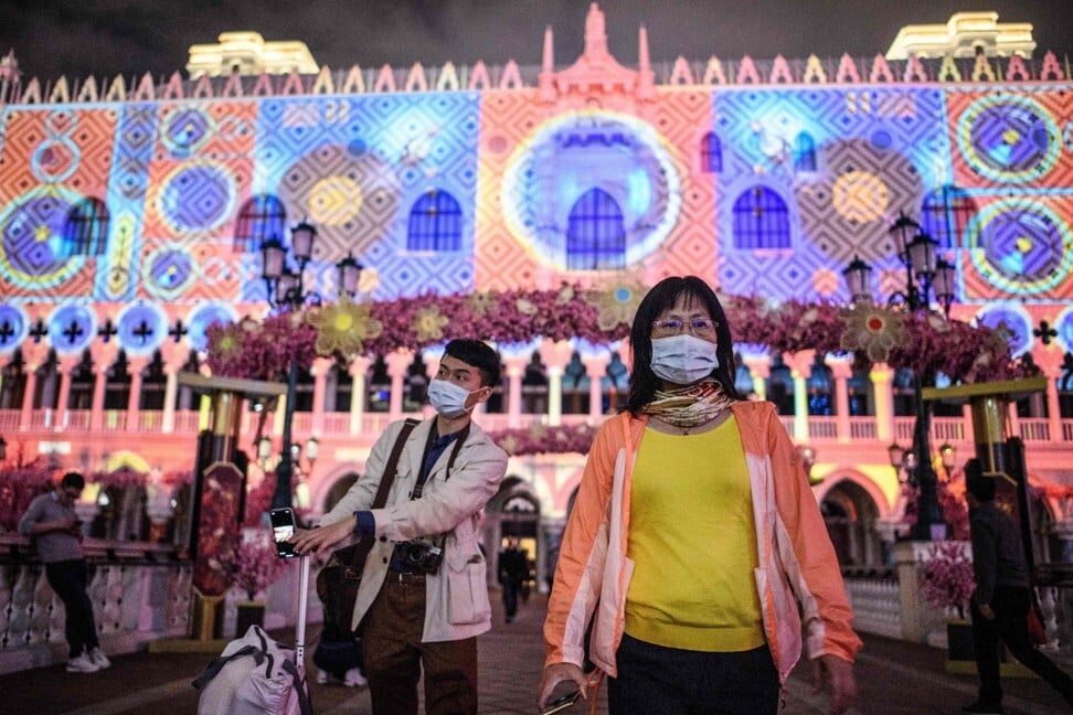 Visitors wear face masks as they walk outside The Venetian Macao, on January 22. Photo: AFP