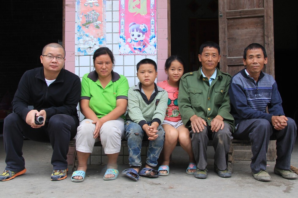 Miners, the Horsekeeper and Pneumoconiosis director Jiang (far left) and Zhao (second right) with his family.