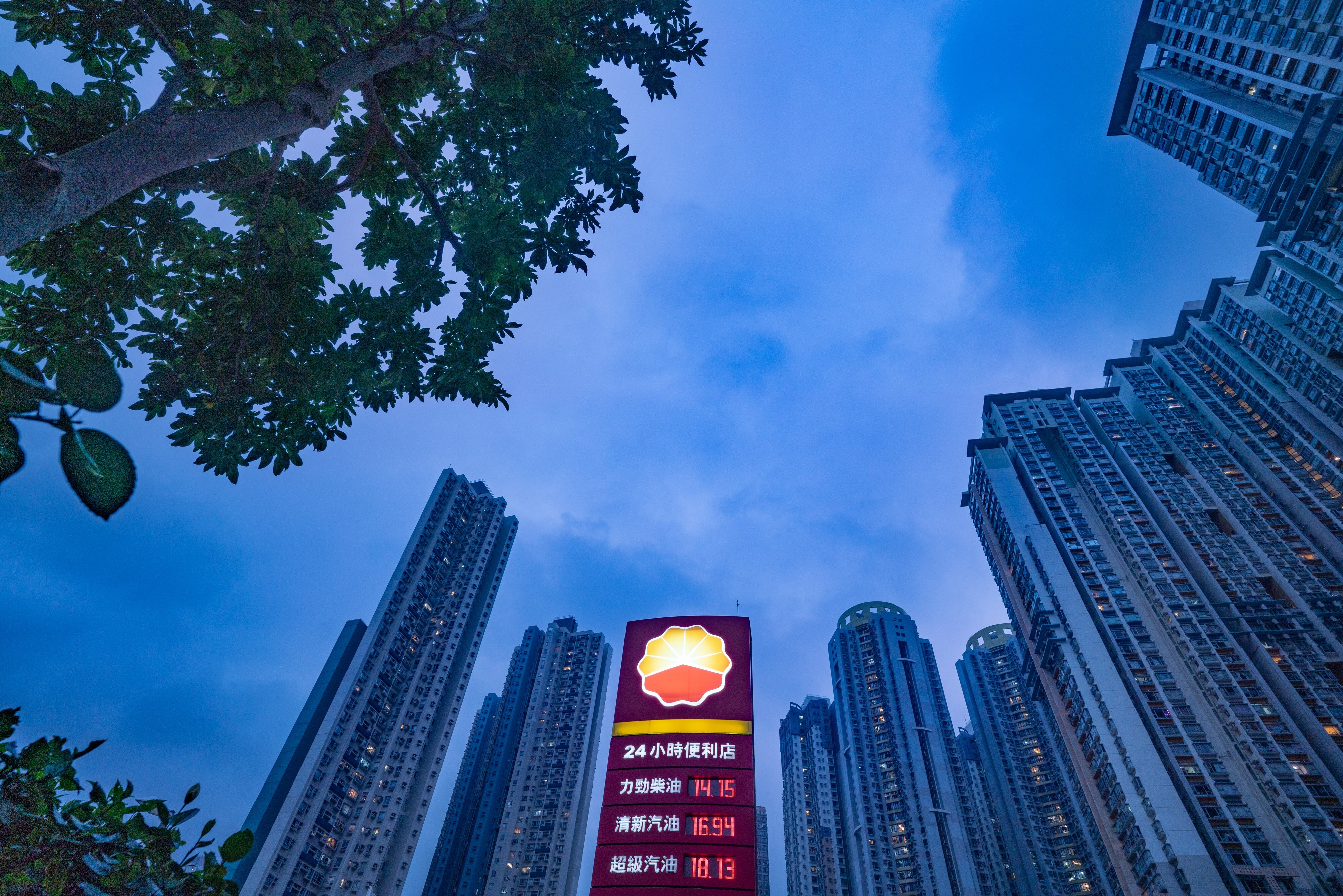Fuel prices are displayed at a PetroChina petrol station in Hong Kong. PetroChina is the most aggressive of the five fuel retailers in the city, spending HK$3.75 billion for 11 sites sold by government tender since April 2009. Photo: Bloomberg