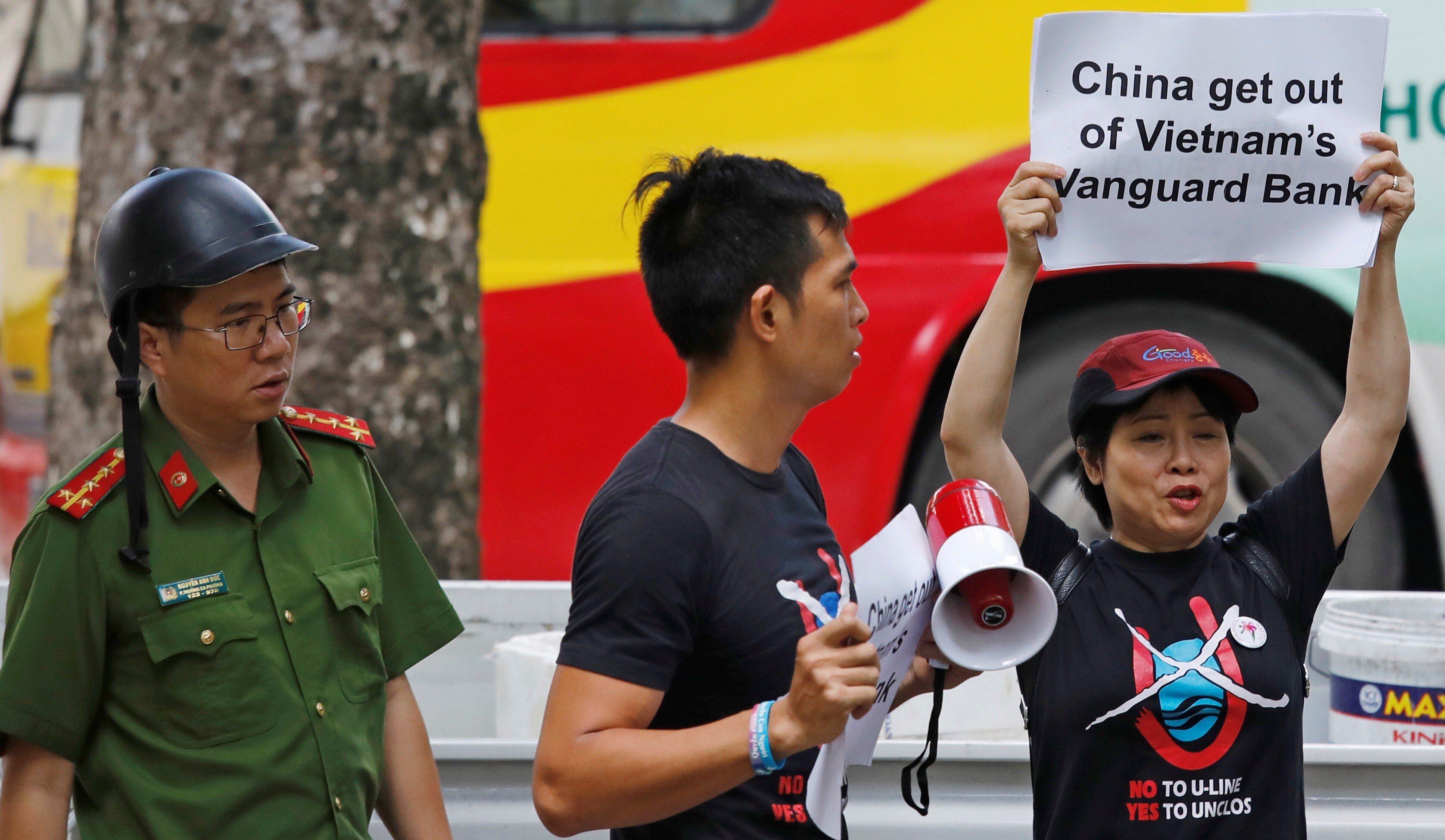 A Vietnamese policeman approaches anti-China protesters during a 2019 demonstration in front of the Chinese embassy in Hanoi, Vietnam. Photo: Reuters