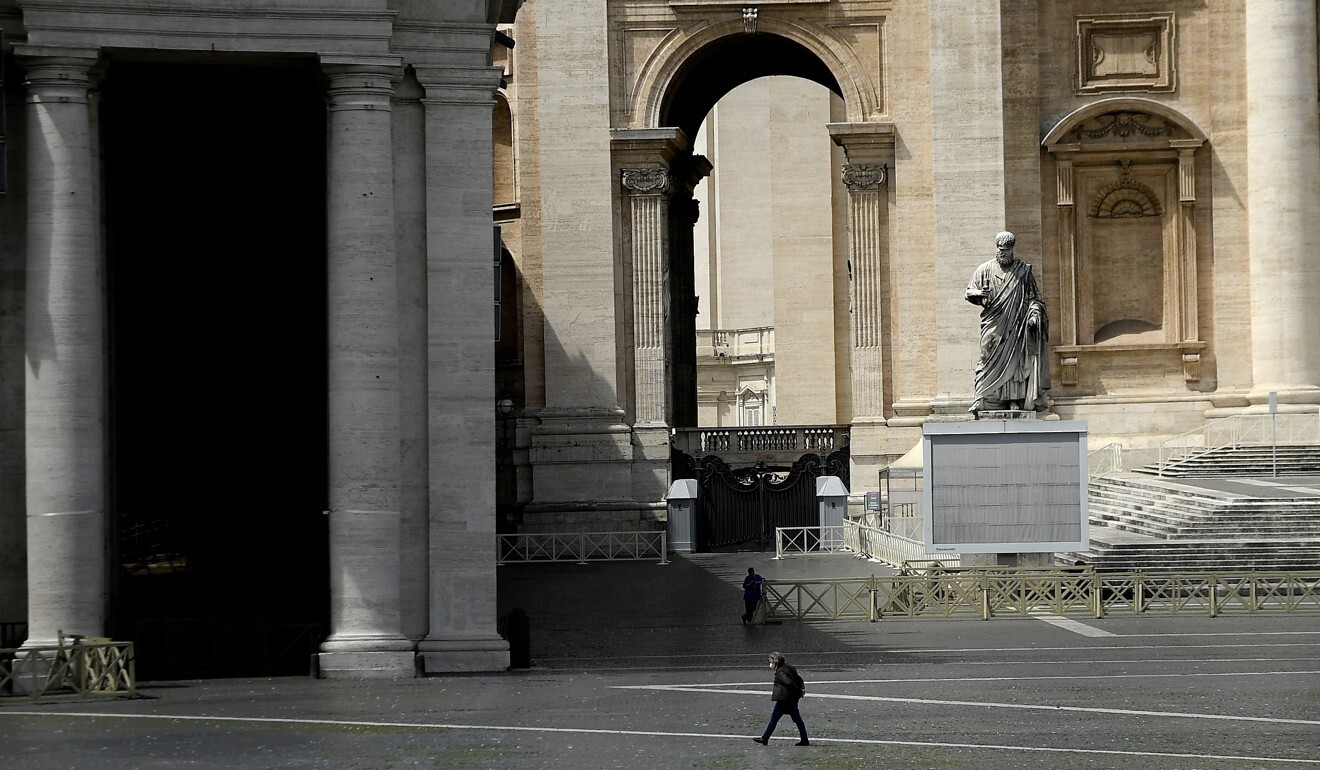 A man wearing a face mask walks in Saint Peter’s Square in Rome during the country's lockdown. Photo: AFP
