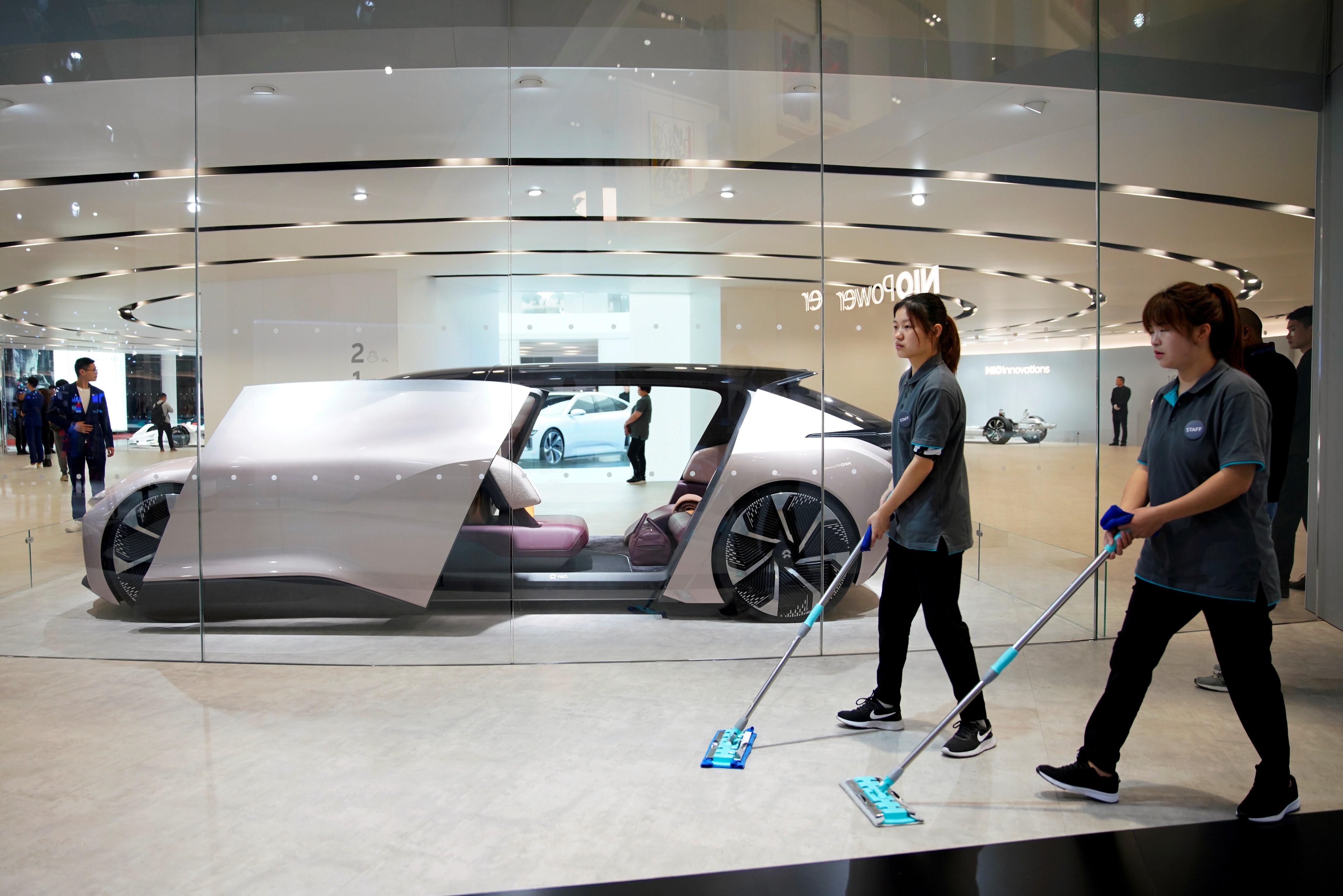 Cleaners are seen next to NIO’s self-driving electric concept car, Eve, displayed at during the Auto Shanghai trade show in April of last year. Photo: Reuters