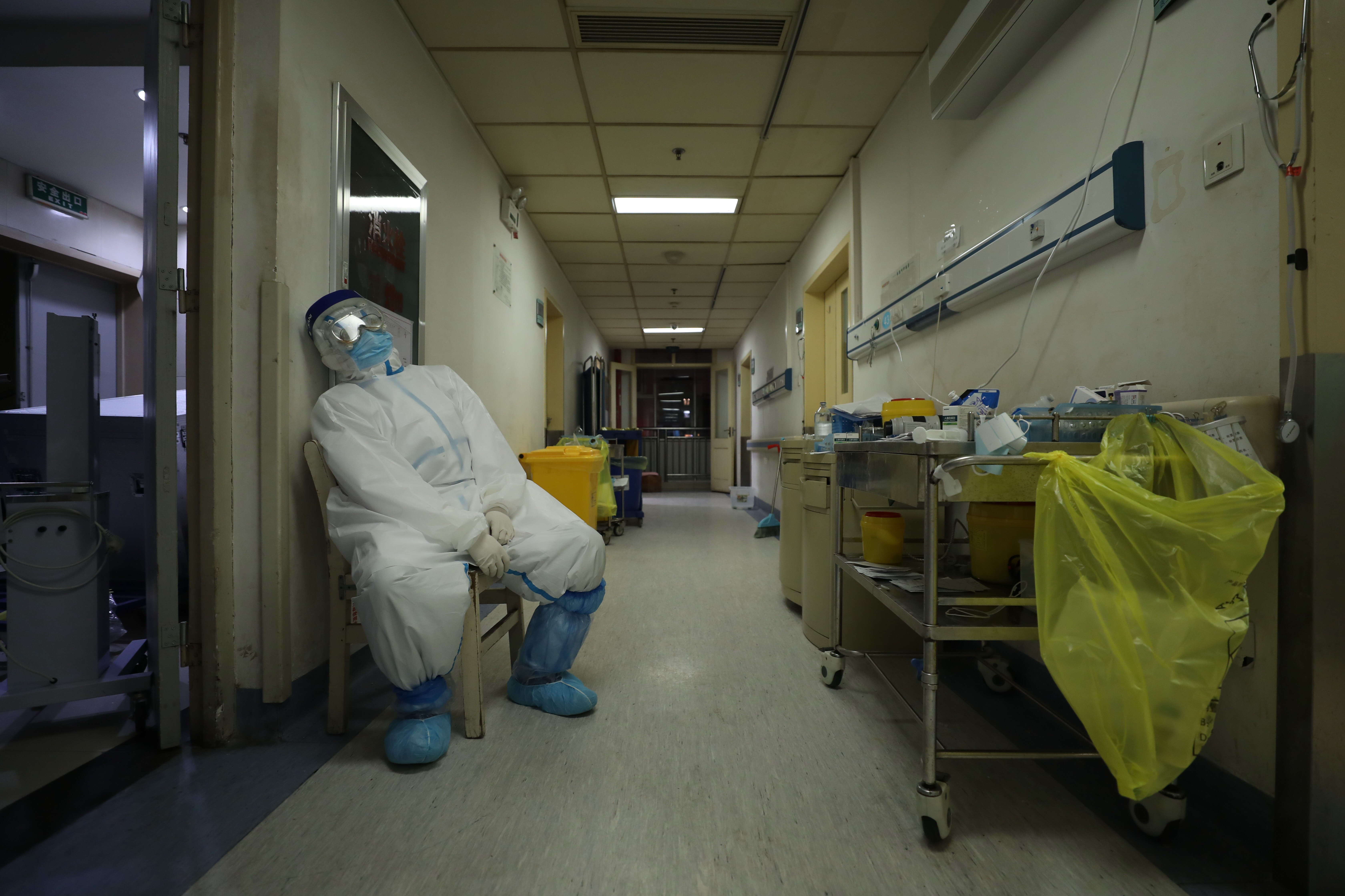 A member of staff takes a break in a hospital designated for Covid-19 patients in Wuhan. Photo: Barcroft Media via Getty Images