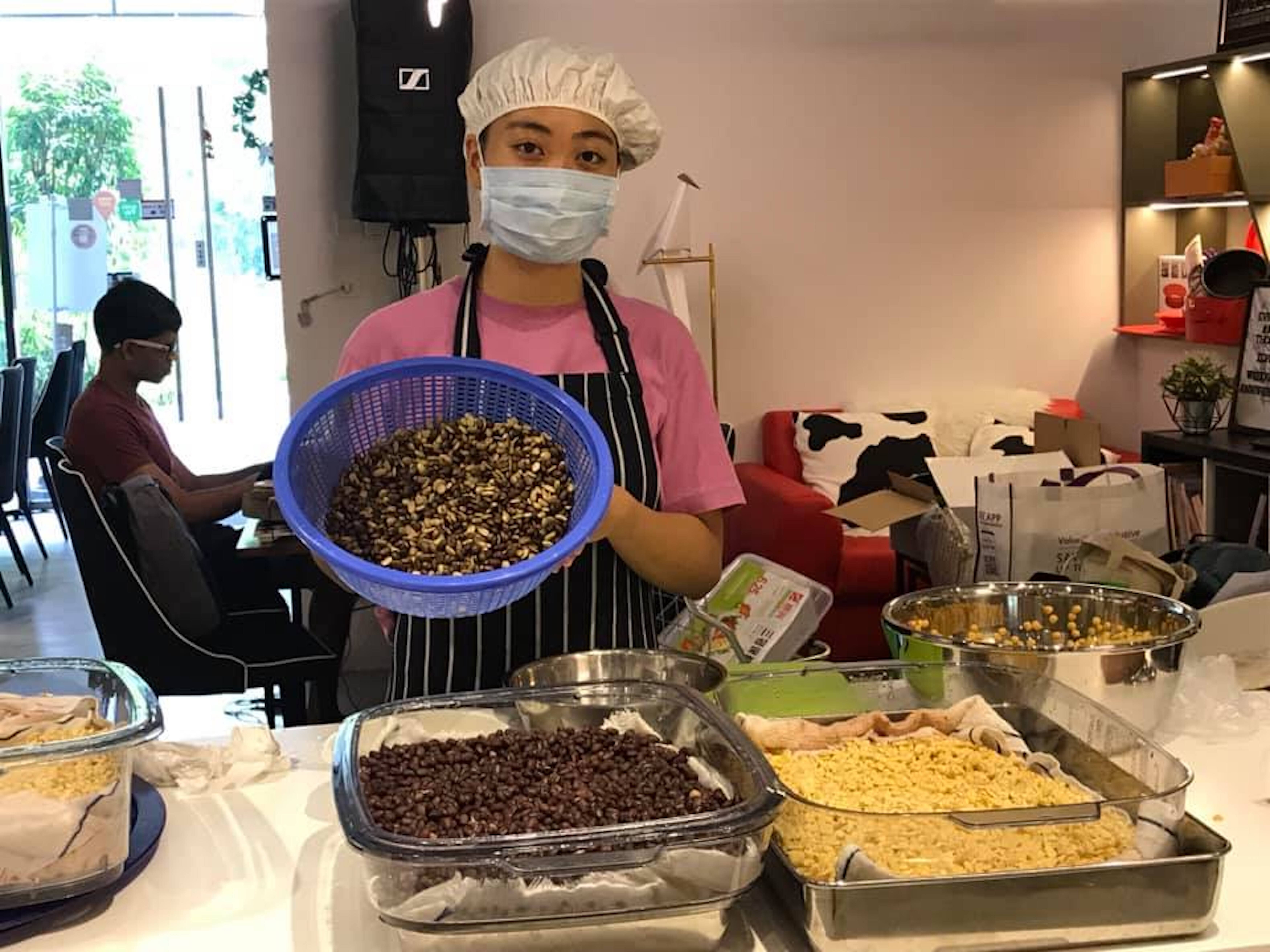 Leong rinses beans to start a new batch of tempeh.