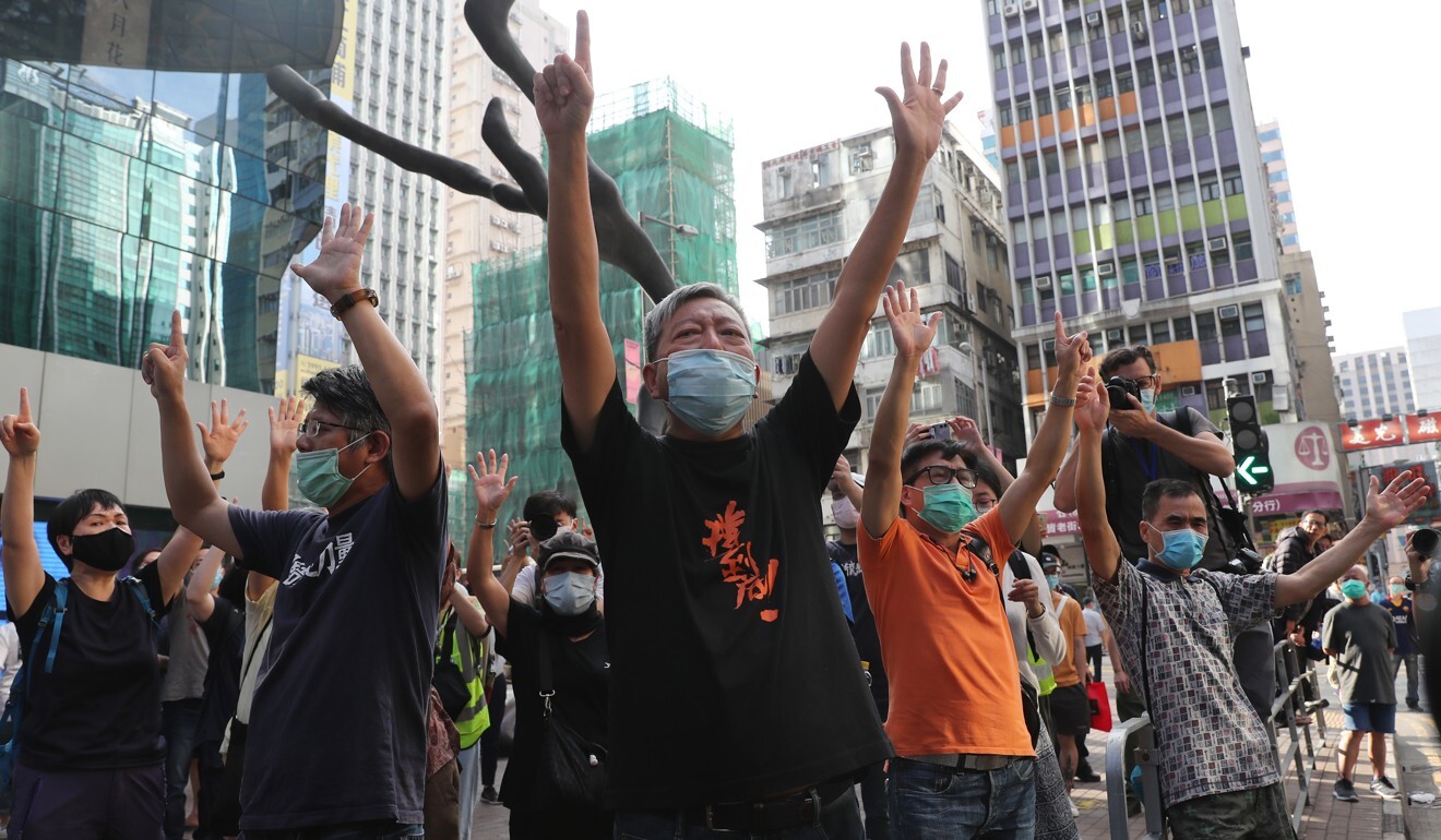Activist Lee Cheuk-yan (centre) and union members flash the “five demands, not one less” sign in Mong Kok. Photo: Sam Tsang