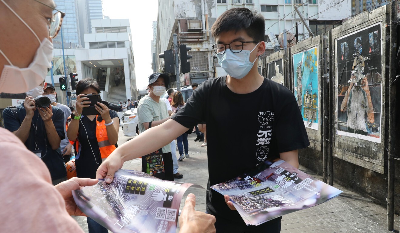 Activist Joshua Wong hands out fliers to pedestrians in Kwun Tong. Photo: Dickson Lee