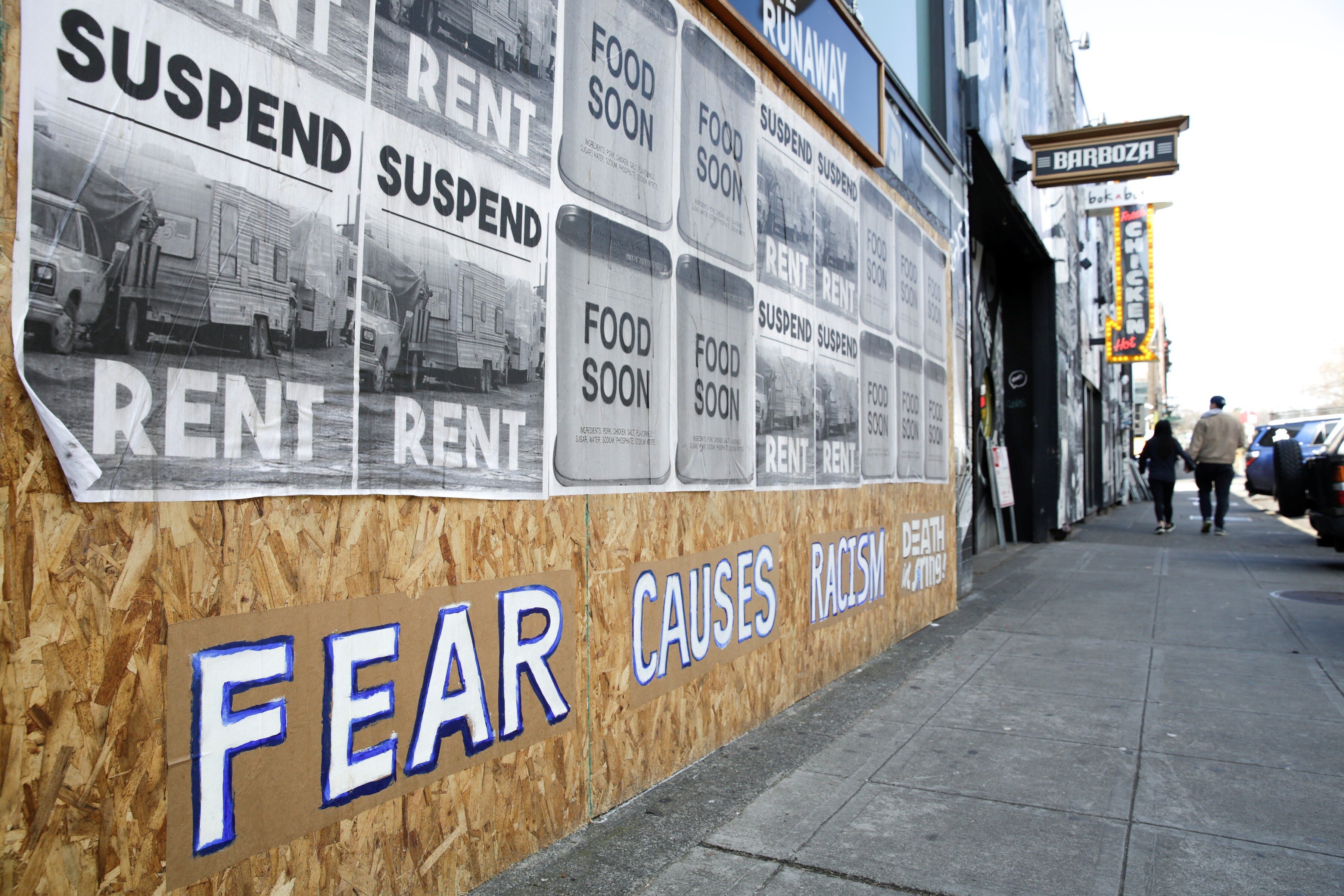 A sign that reads “Fear causes racism” is seen on a boarded-up shopfront in Seattle, Washington, in March. Photo: Reuters