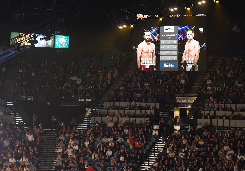 The UFC 244 main event between Jorge Masvidal and Nate Diaz is shown on screens at MGM Grand Garden Arena. Boxing partners DAZN network and Golden Boy Promotions delayed the start of the WBO light heavyweight title fight between Canelo Alvarez and Sergey Kovalev until after the conclusion of UFC’s pay-per-view event. Photo: AFP
