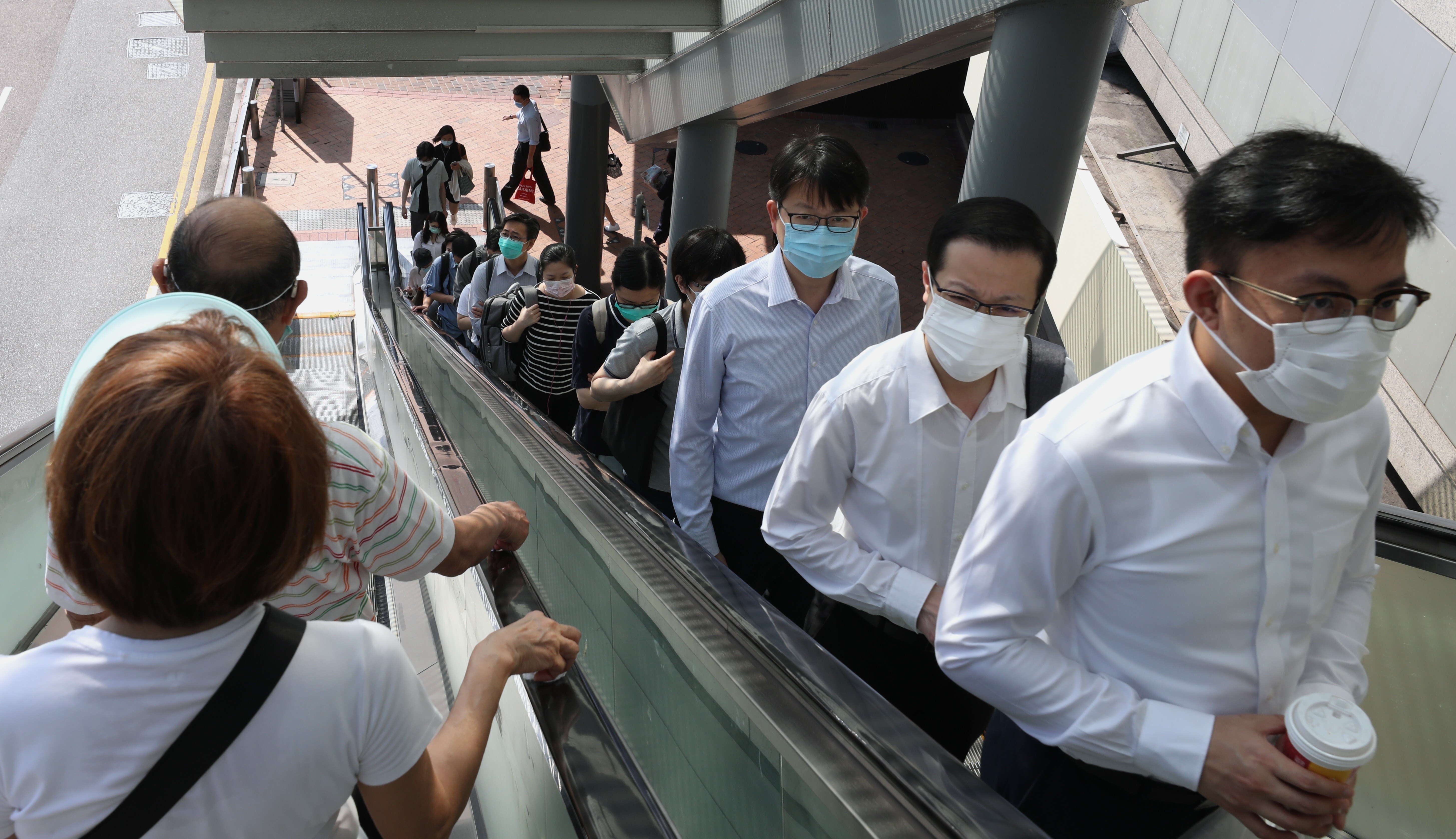 Civil servants go back to work at the government headquarters in Admiralty on May 4, as Hong Kong starts to relax Covid-19 measures. Photo: Nora Tam