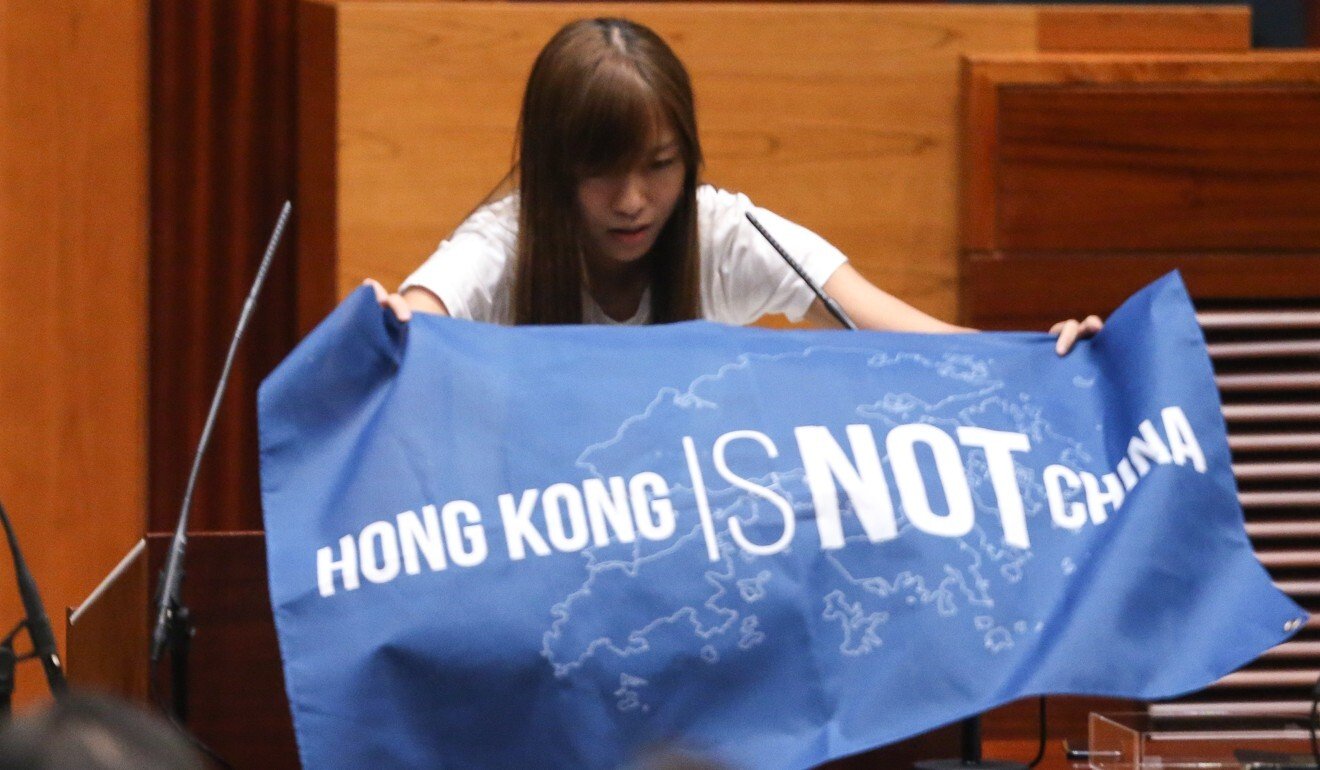 Lawmaker-elect Yau Wai-ching displays a banner reading during a Legislative Council oath-taking session in October 2016. Photo: Sam Tsang