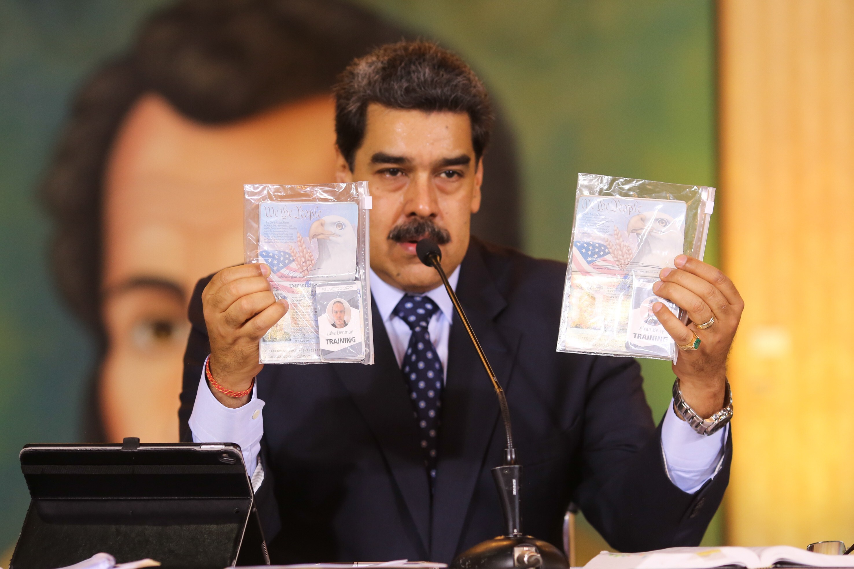 Venezuela’s President Nicolas Maduro shows what Venezuelan authorities claim are identification documents of US citizens Airan Berry and Luke Denman during an online press conference in Caracas on Wednesday. Photo: Miraflores Palace presidential press office via AP