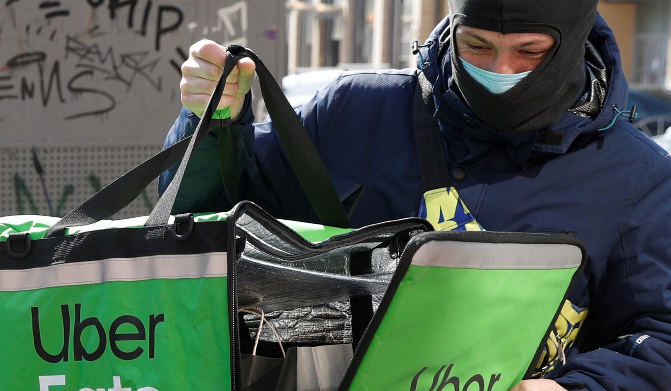 An Uber Eats food delivery courier closes a bag with an order during a lockdown, imposed to prevent the spread of coronavirus disease (COVID-19), in central Kiev, Ukraine April 2, 2020. Photo: Reuters