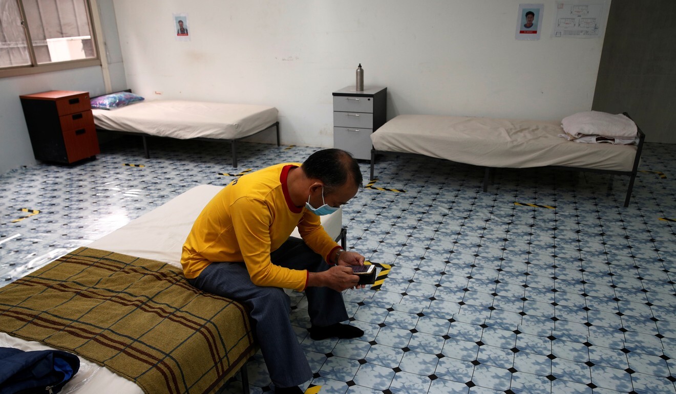 A migrant worker sits on his bed in temporary living quarters at a train station construction site. Photo: Reuters