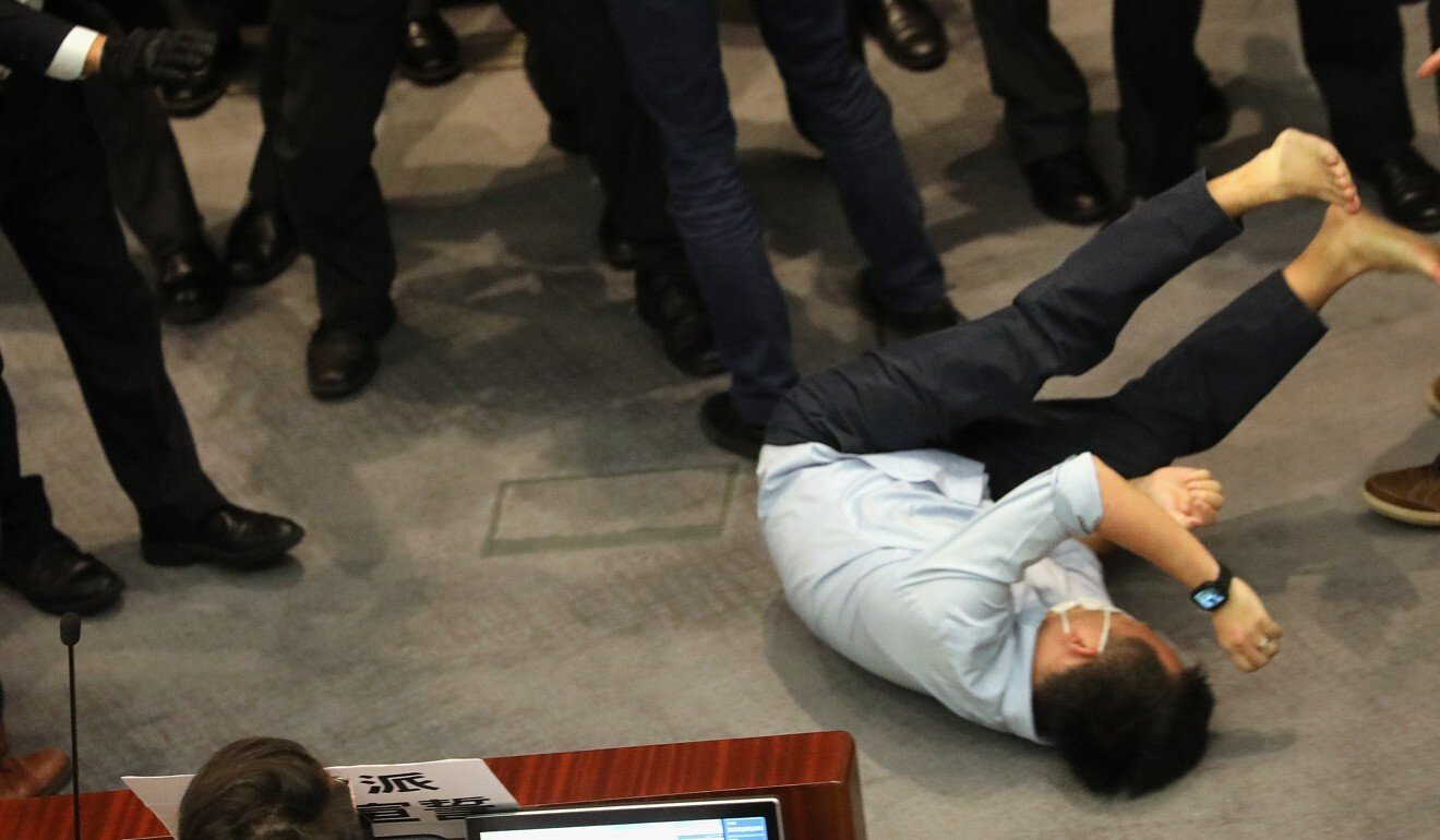 Lawmaker Raymond Chan falls to the ground. Photo: Dickson Lee