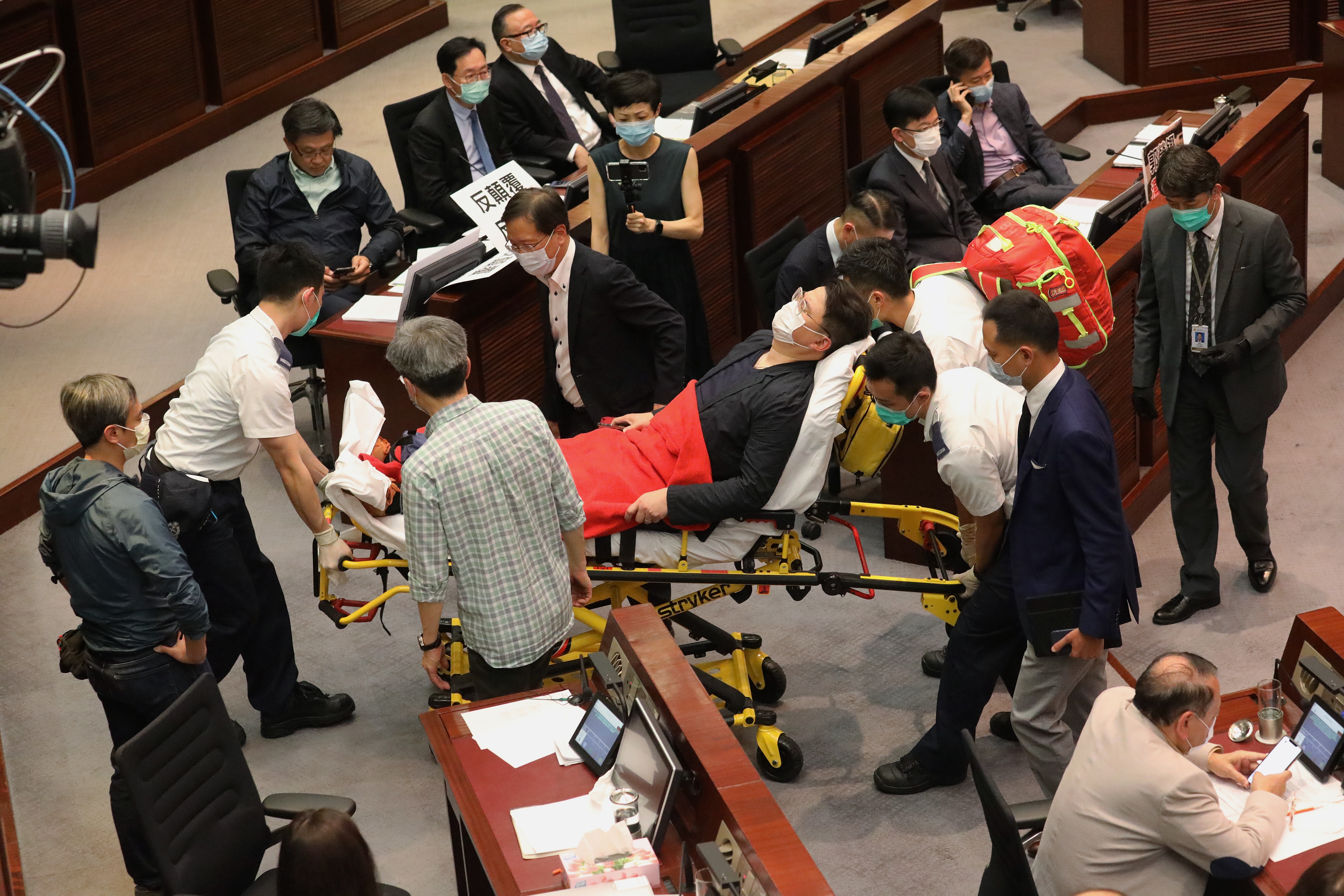 Lawmaker Andrew Wan is carried out by medical staff in Legco as chaos breaks out. Photo: Dickson Lee