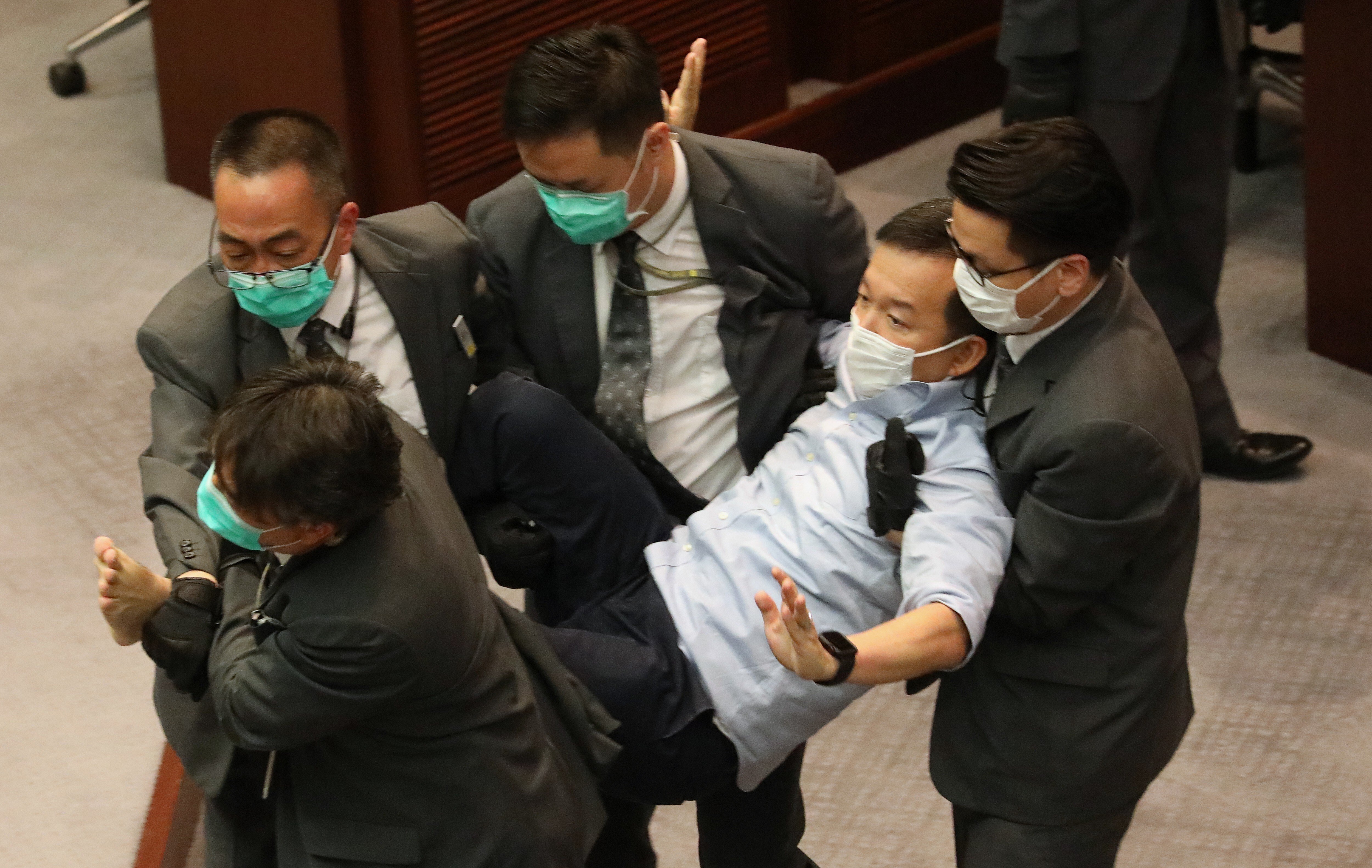 Pan-democrat lawmaker Raymond Chan, pictured being removed from Legco’s chamber, is among those to make allegations relating to Friday’s mayhem. Photo: Dickson Lee