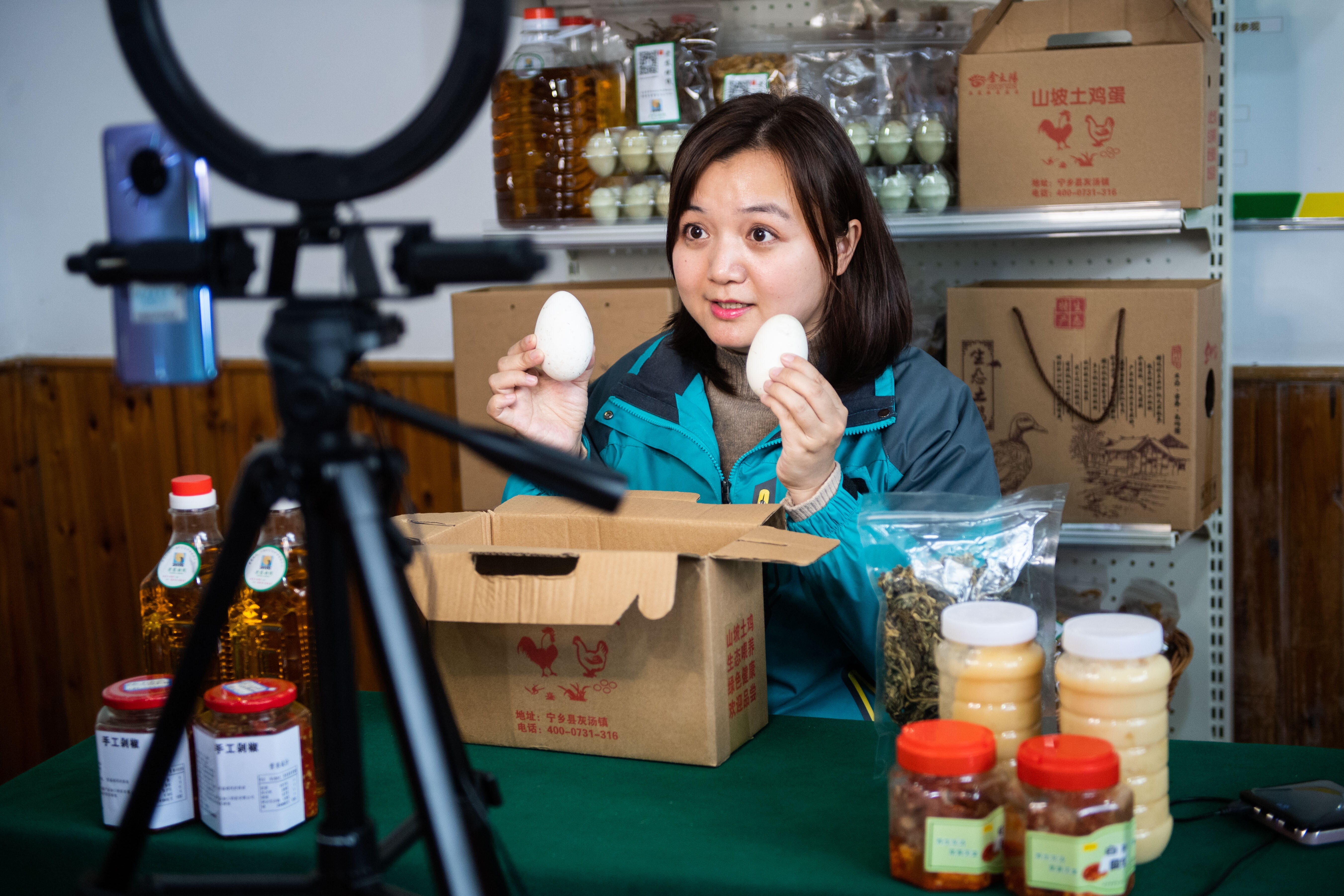 Zhang Qin, an overseas returnee, introduces eggs via live-streaming on an e-commerce platform she founded in Huitang Village of Huitang County, central China's Hunan Province, March 13, 2020. Photo: Xinhua